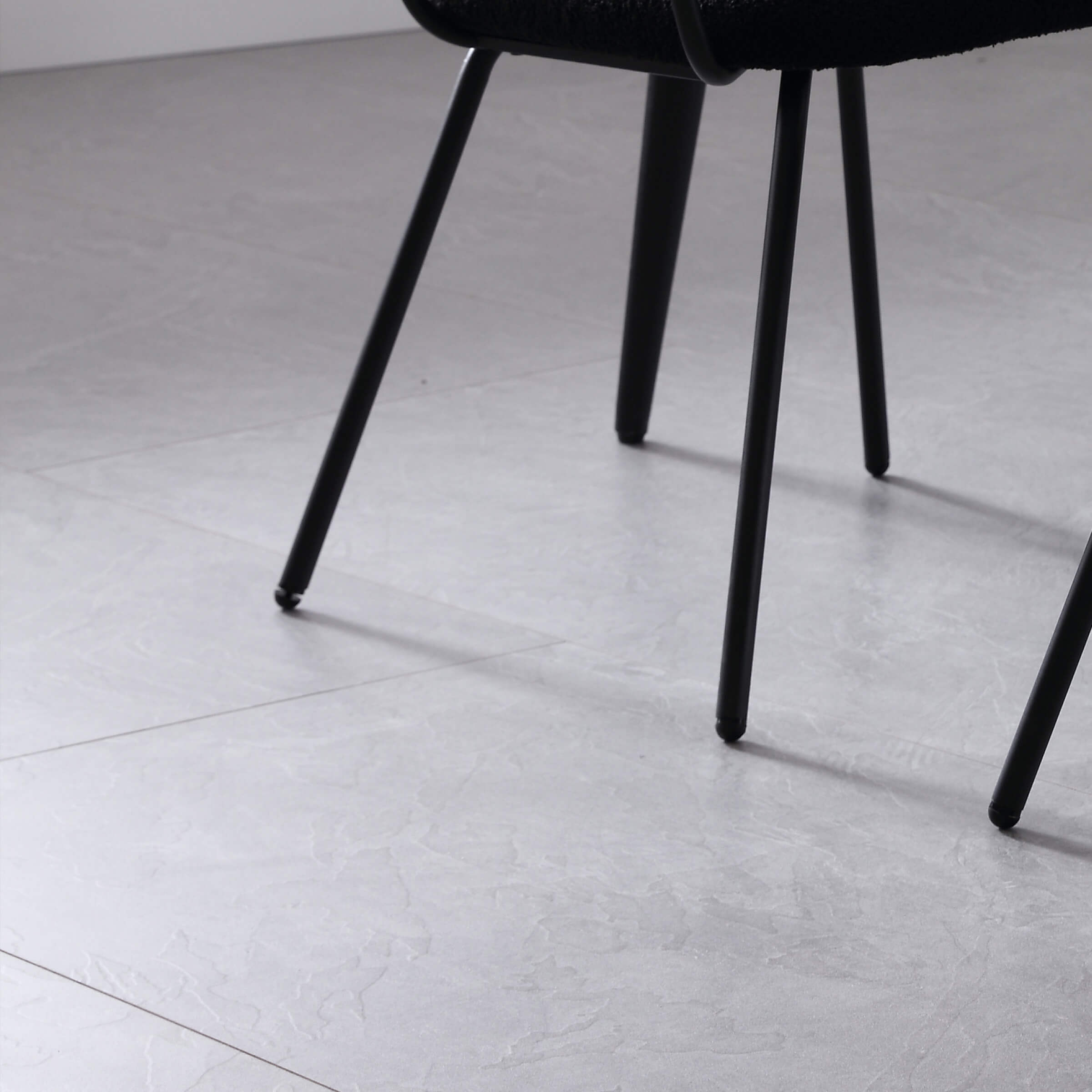 Chair legs and foot caps on tile floor
