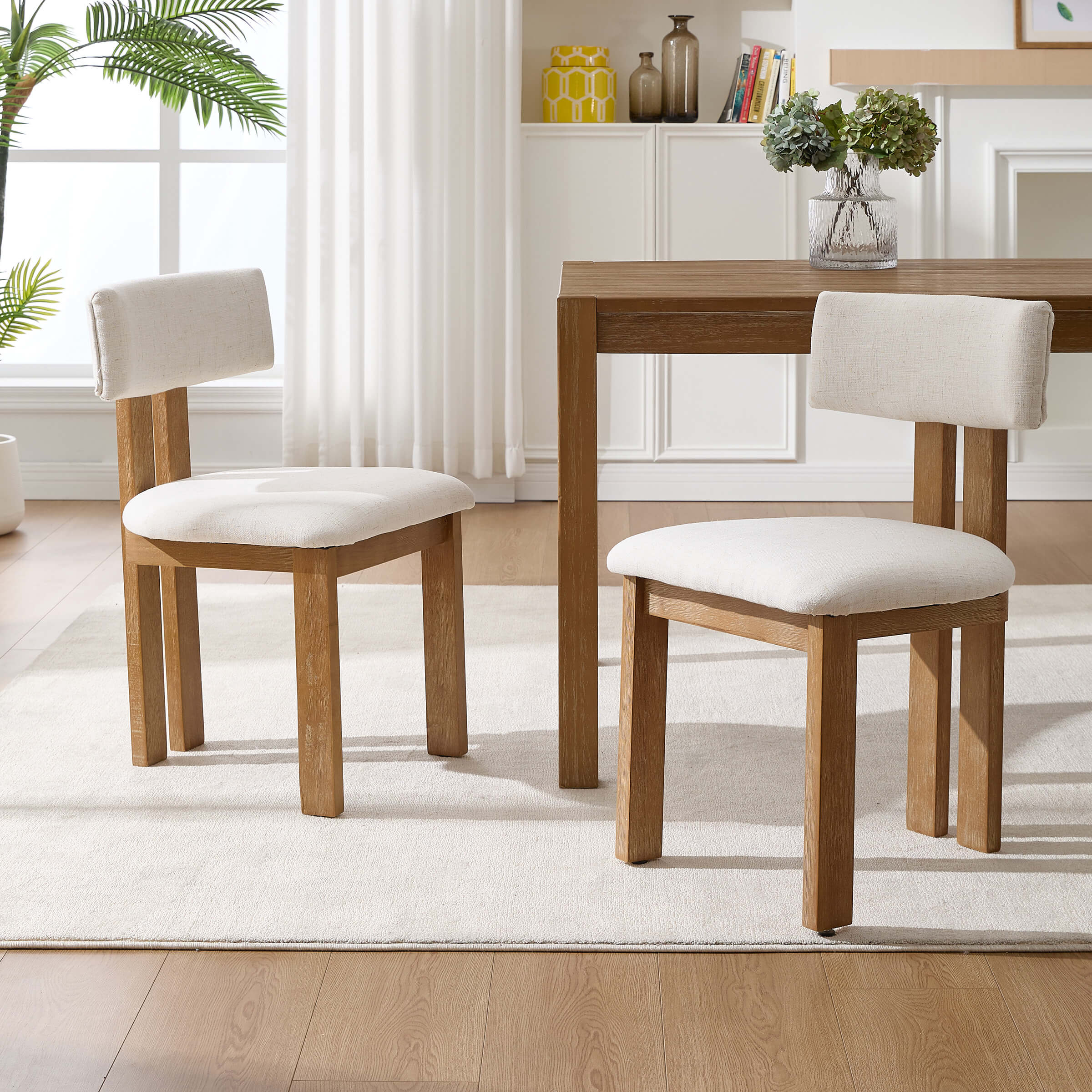 White upholstery chairs around table in bright room