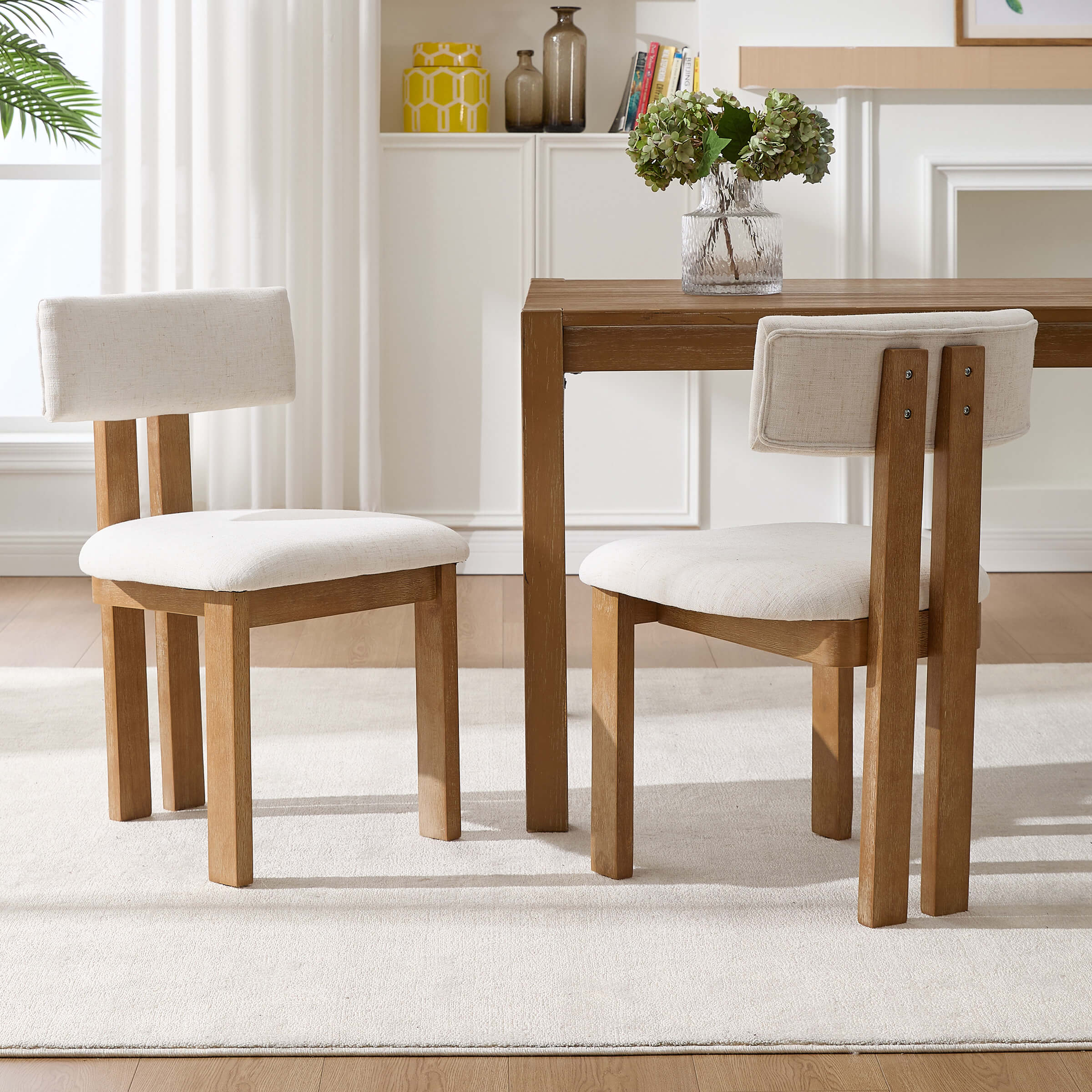 Cream chairs around table on white rug