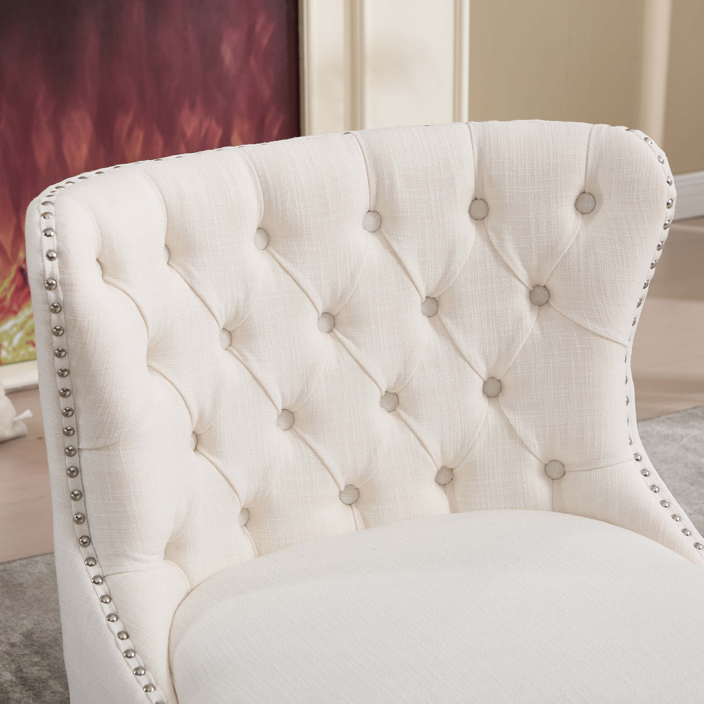 Close-up of tufted back with buttons and nailhead trim
