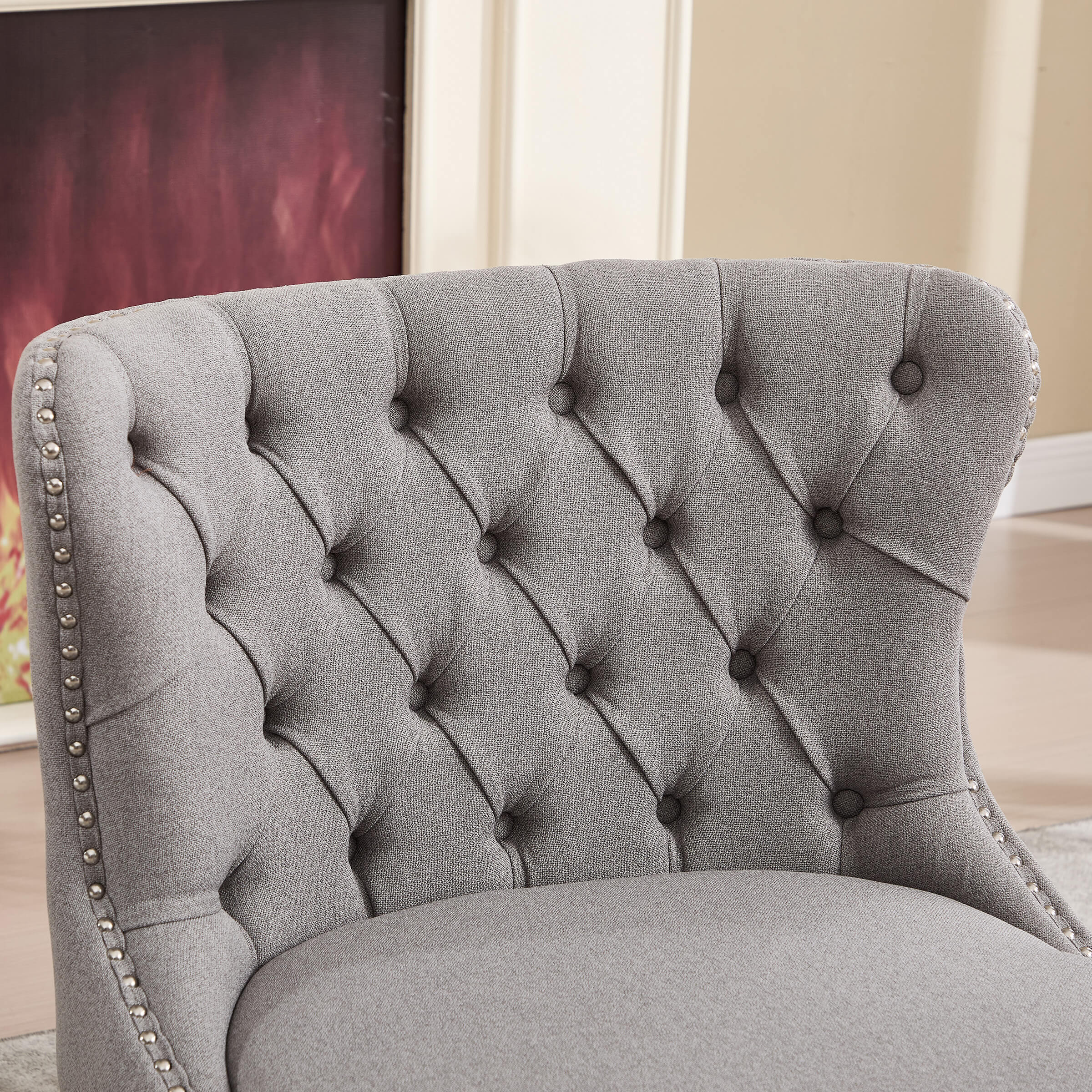 Close-up of grey tufted slipper chair back showing button tufting