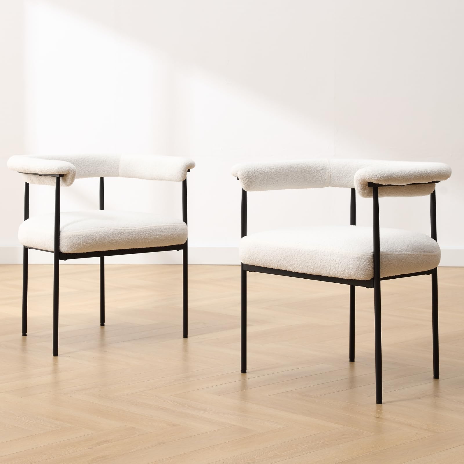 Two white chairs in bright room