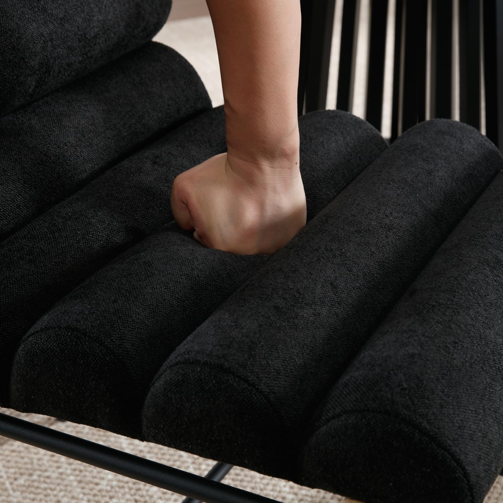 Close-up of hand pressing seat cushion