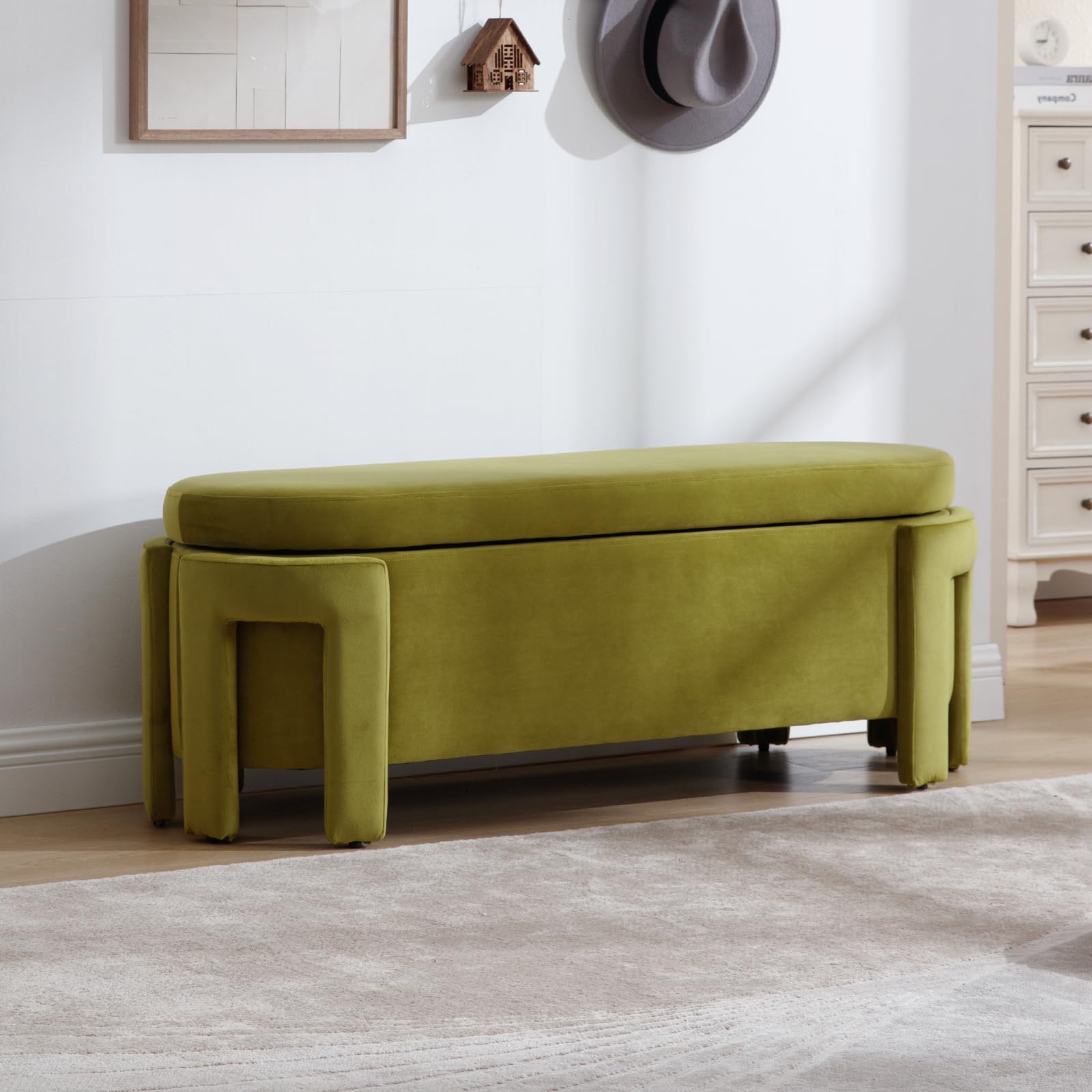 Green velvet storage bench at foot of bed