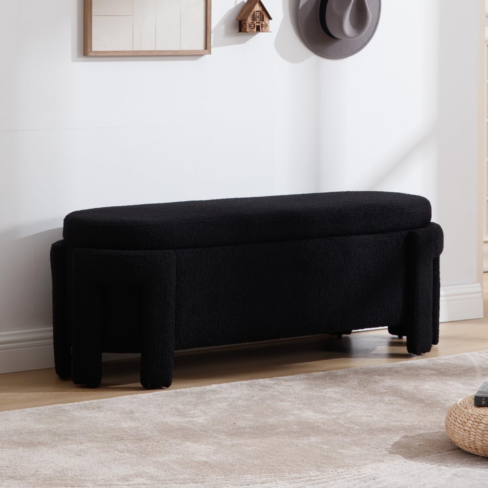 Black velvet storage bench in room