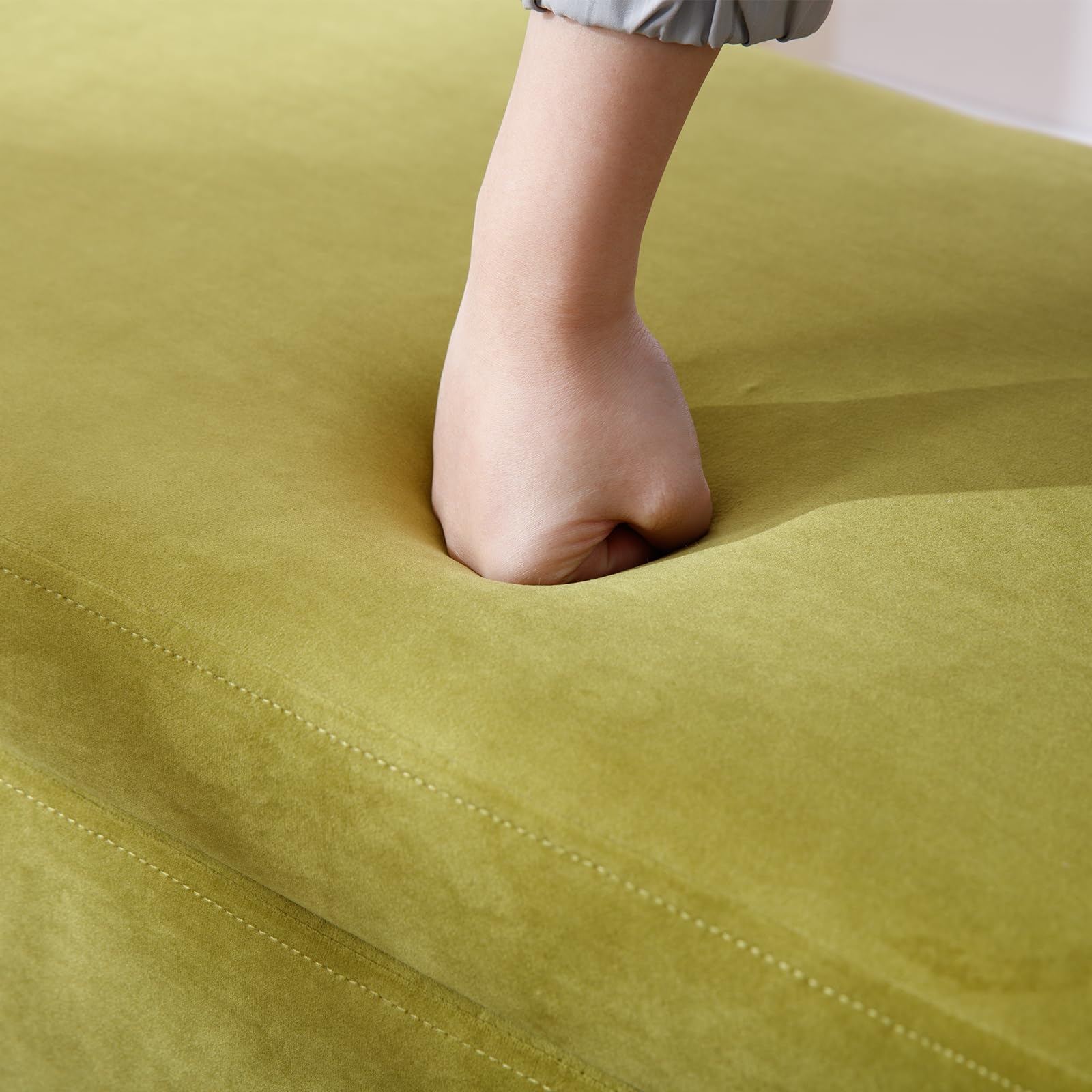 Top surface of olive green bench being pressed