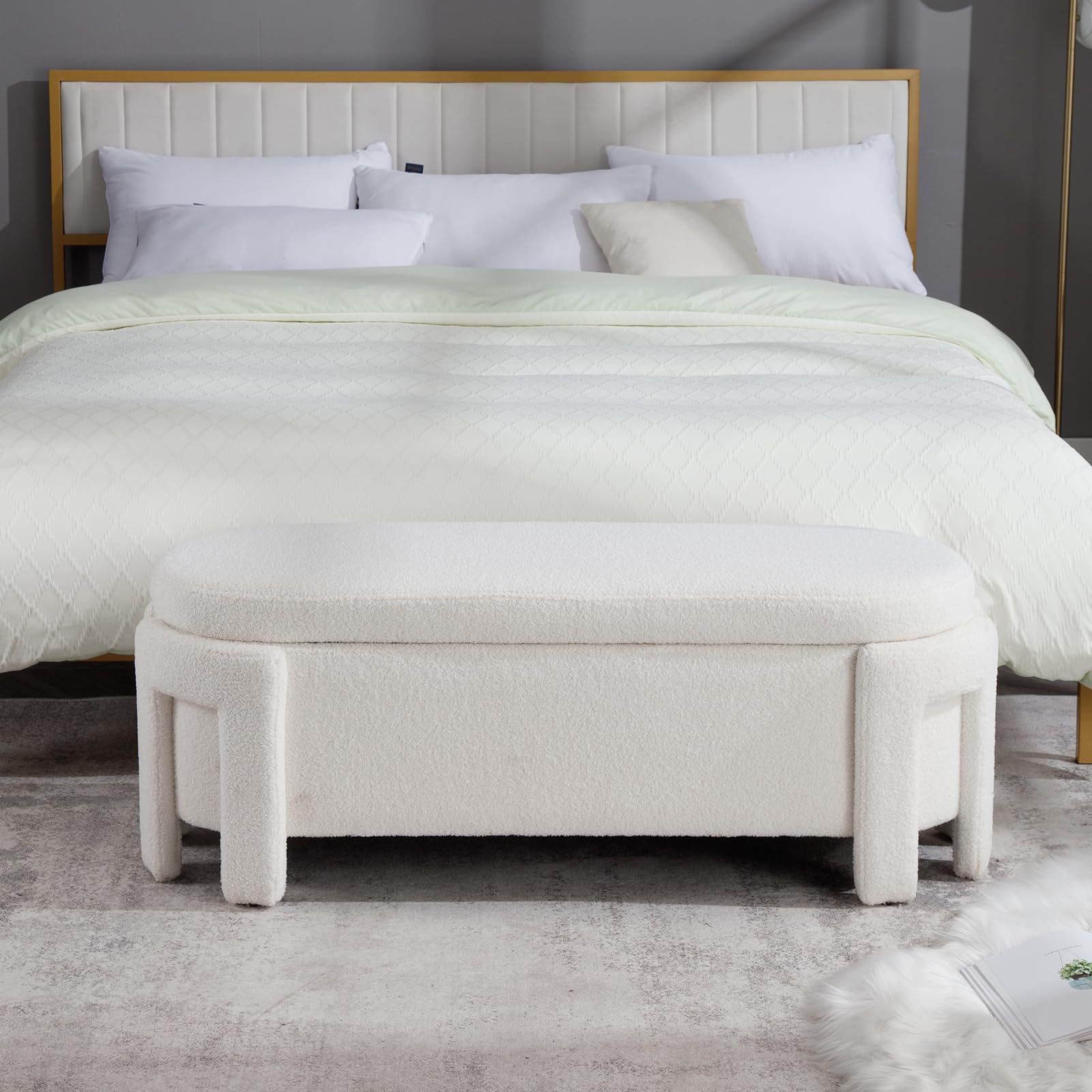 White velvet storage bench at foot of bed