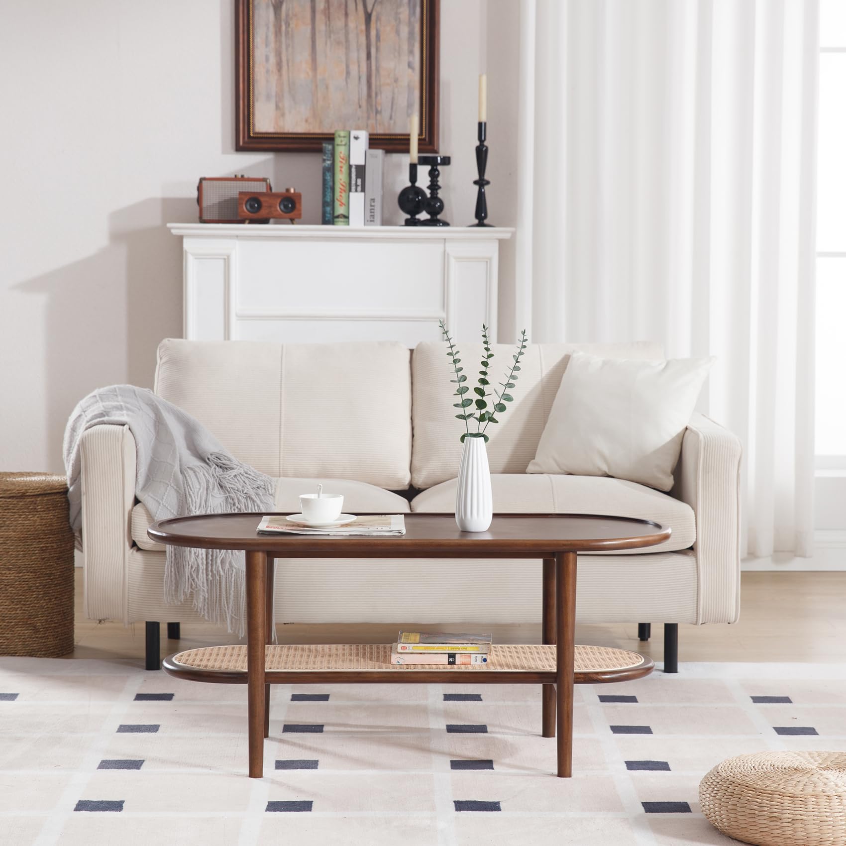 Living room with white sofa, oval coffee table, and decor