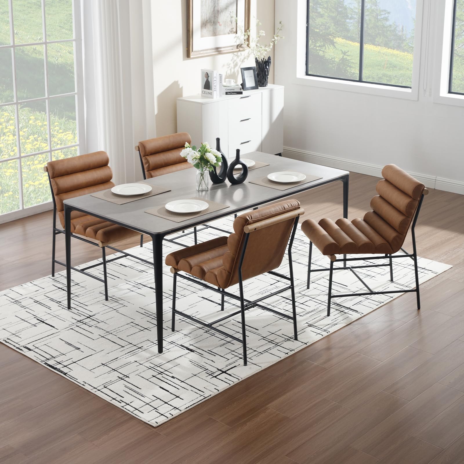 Table with four chairs around it in a bright room