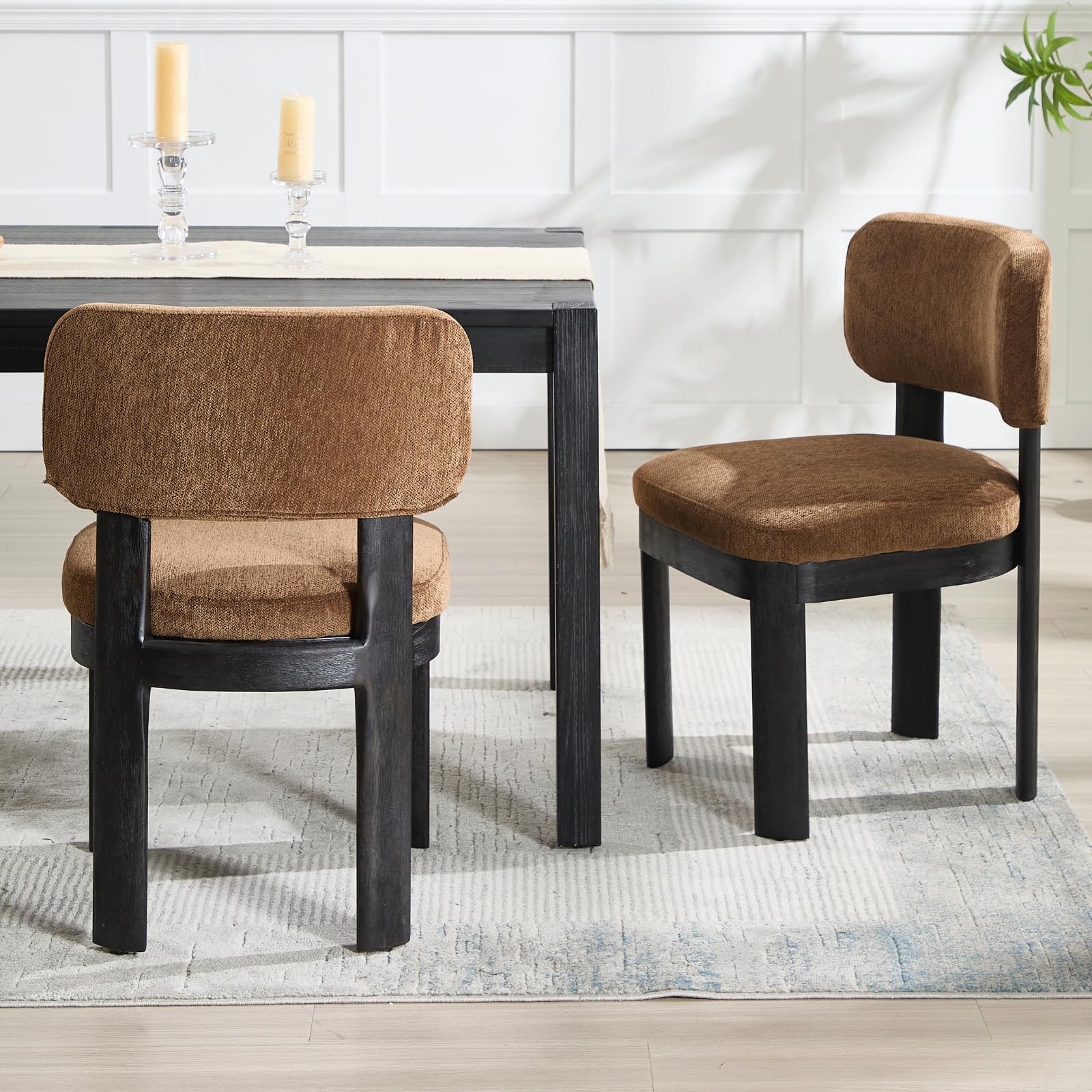Two brown chairs around table with candles