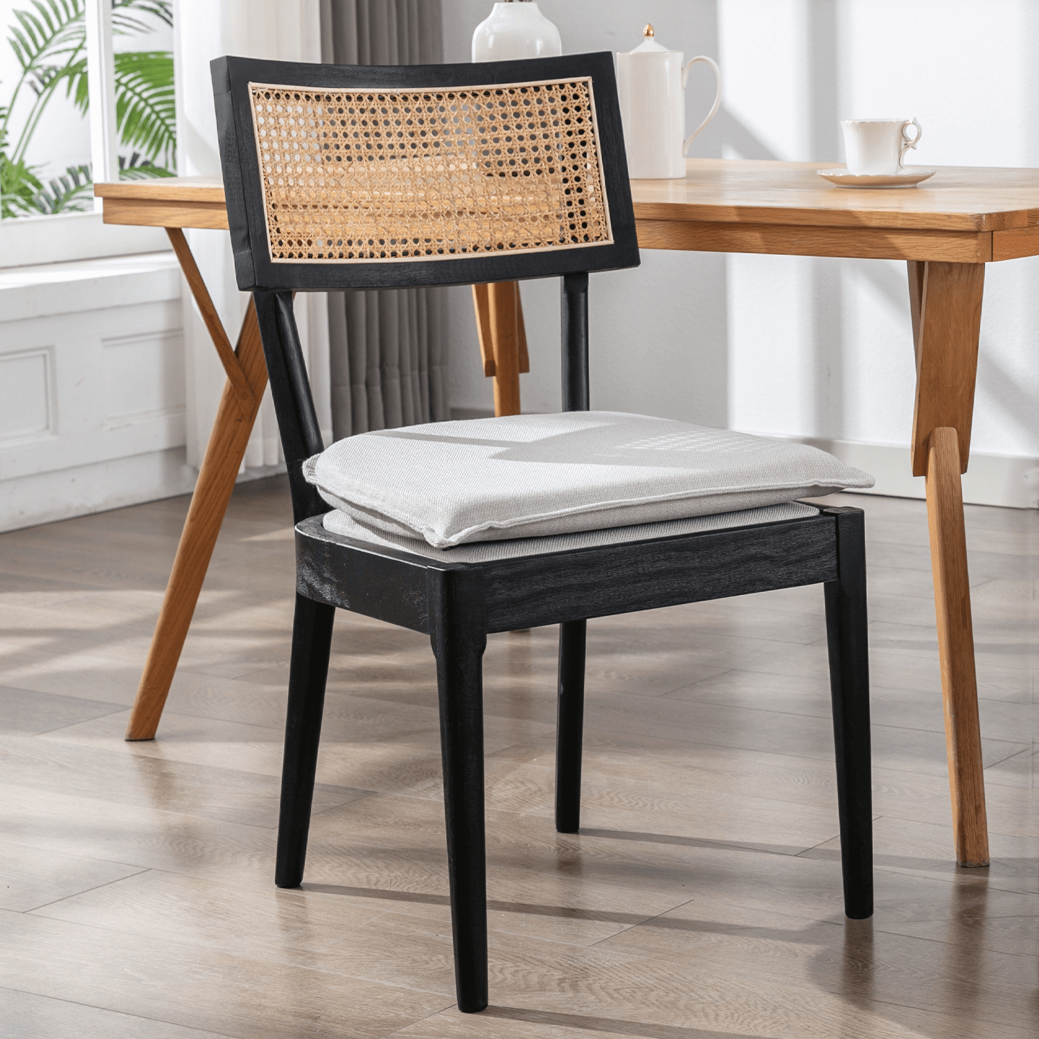 One black chair with caned back