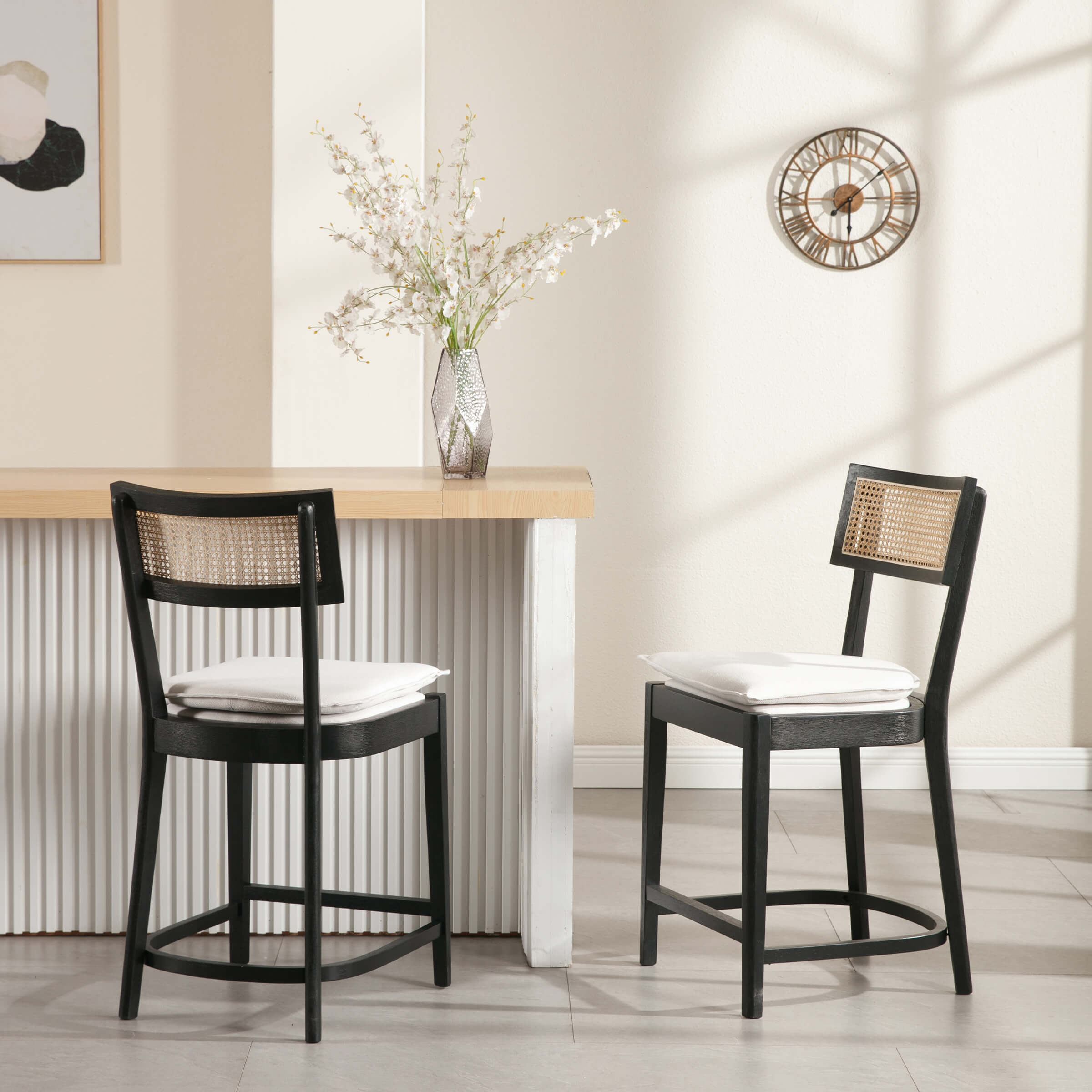 Two black wood counter stools placed at a wooden bar counter