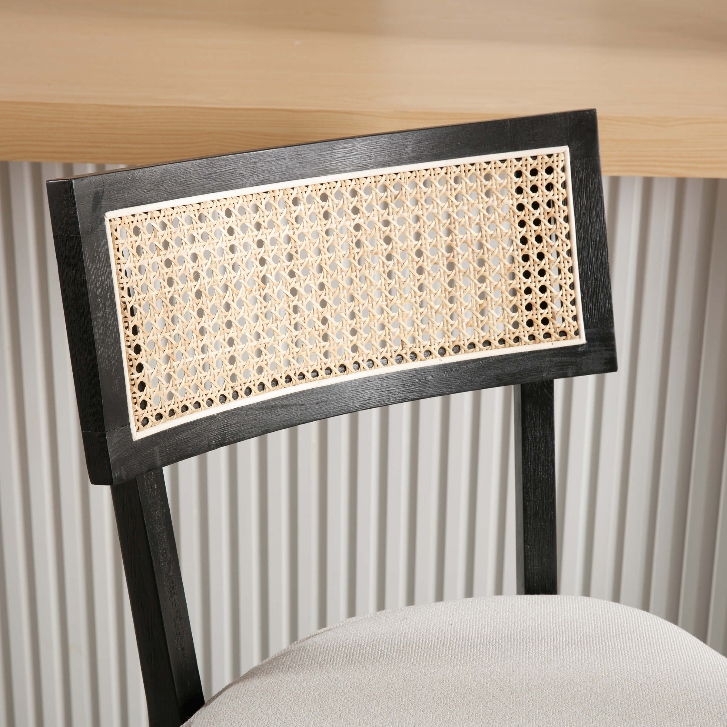 Close-up of cane-back panel on stool