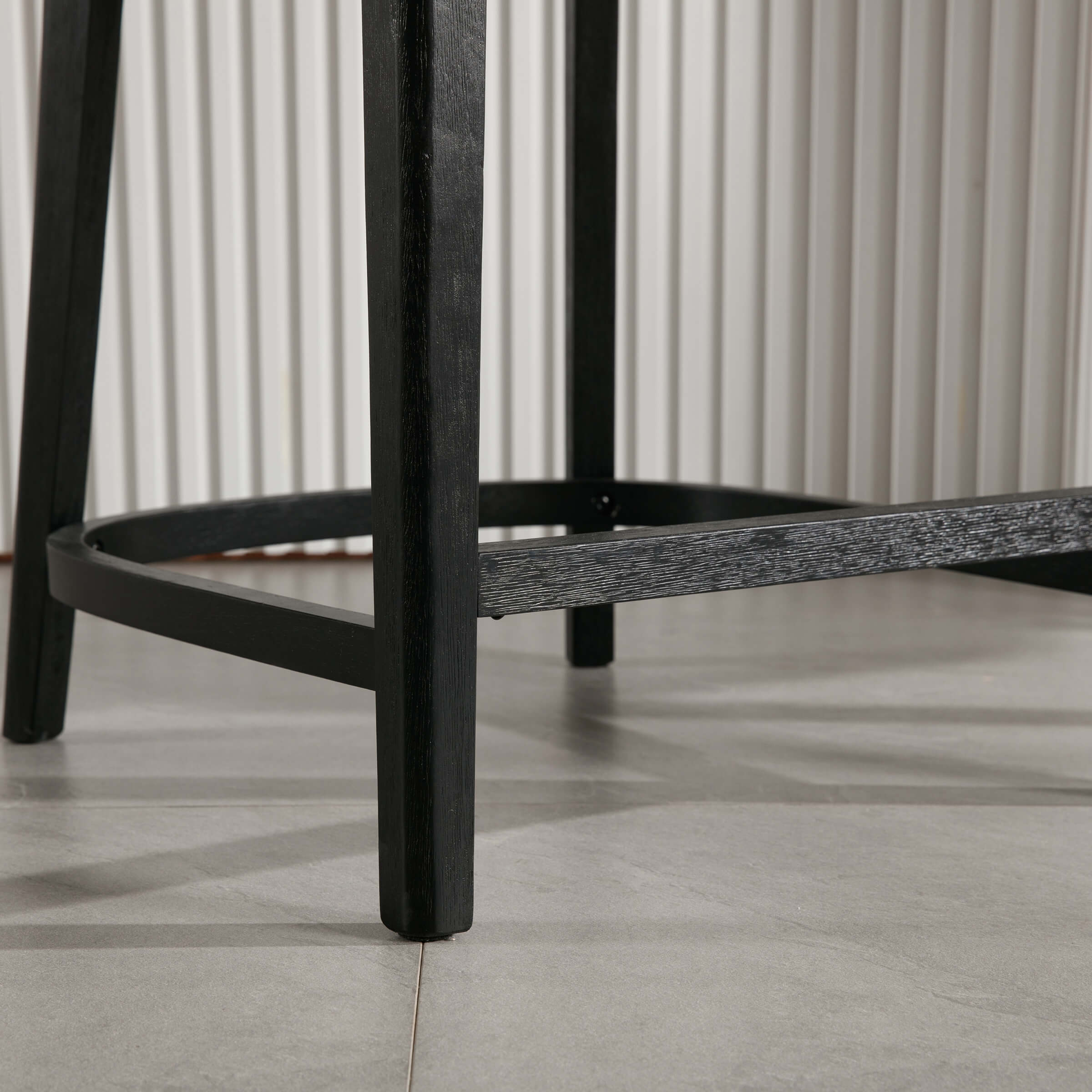 Close-up of stool leg and circular footrest