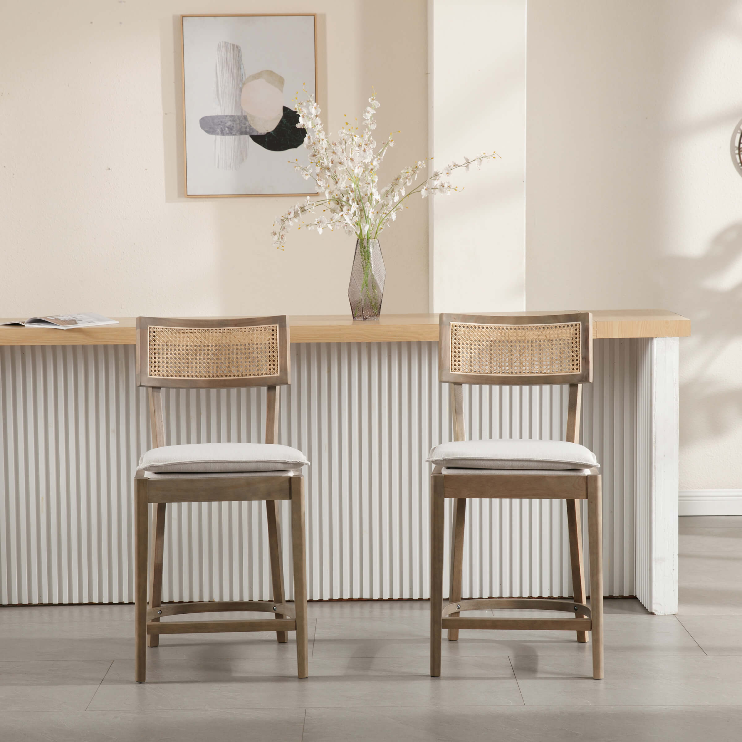 Two stools with cane-back design in lighter wood tone