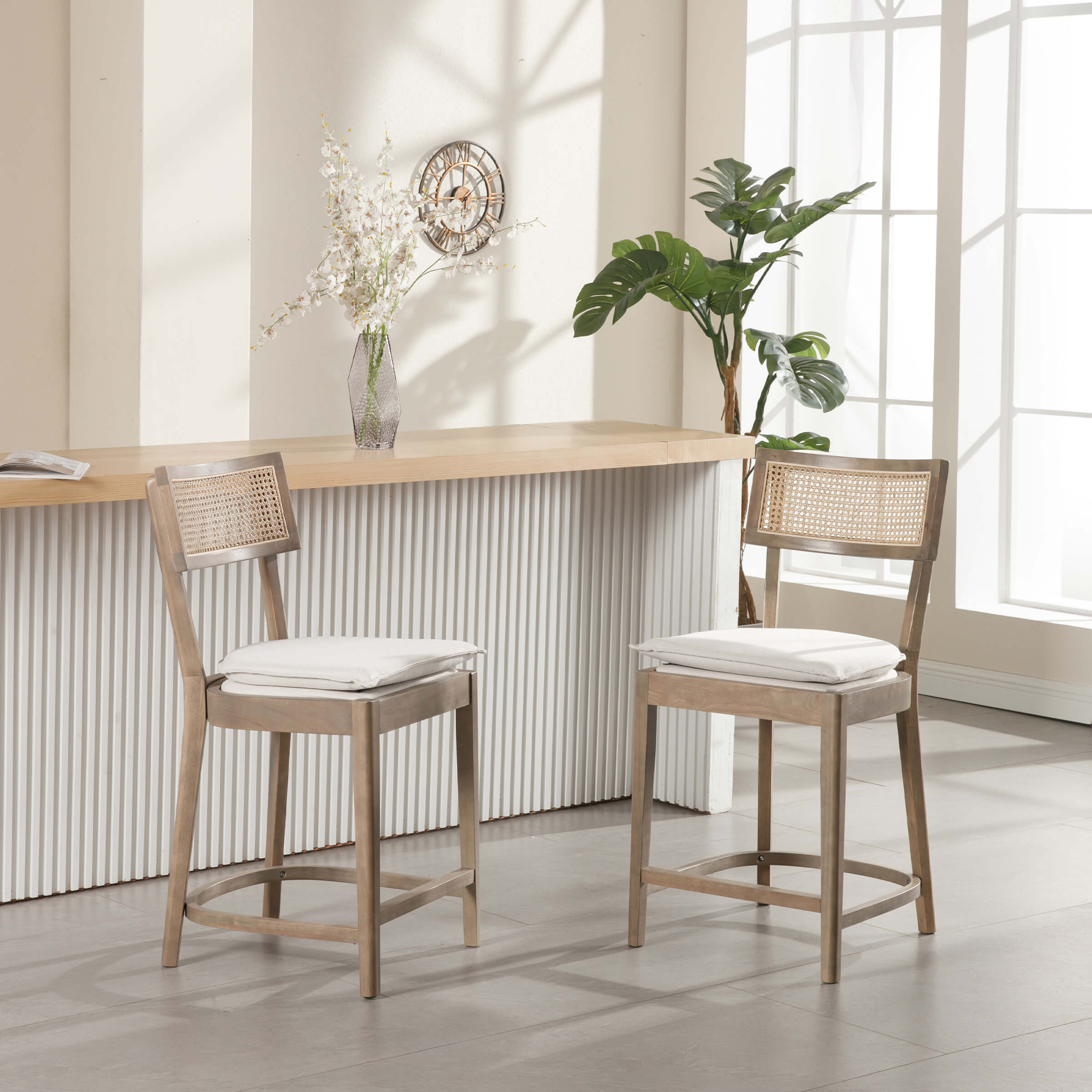 Two stools at bar with plant and corner window