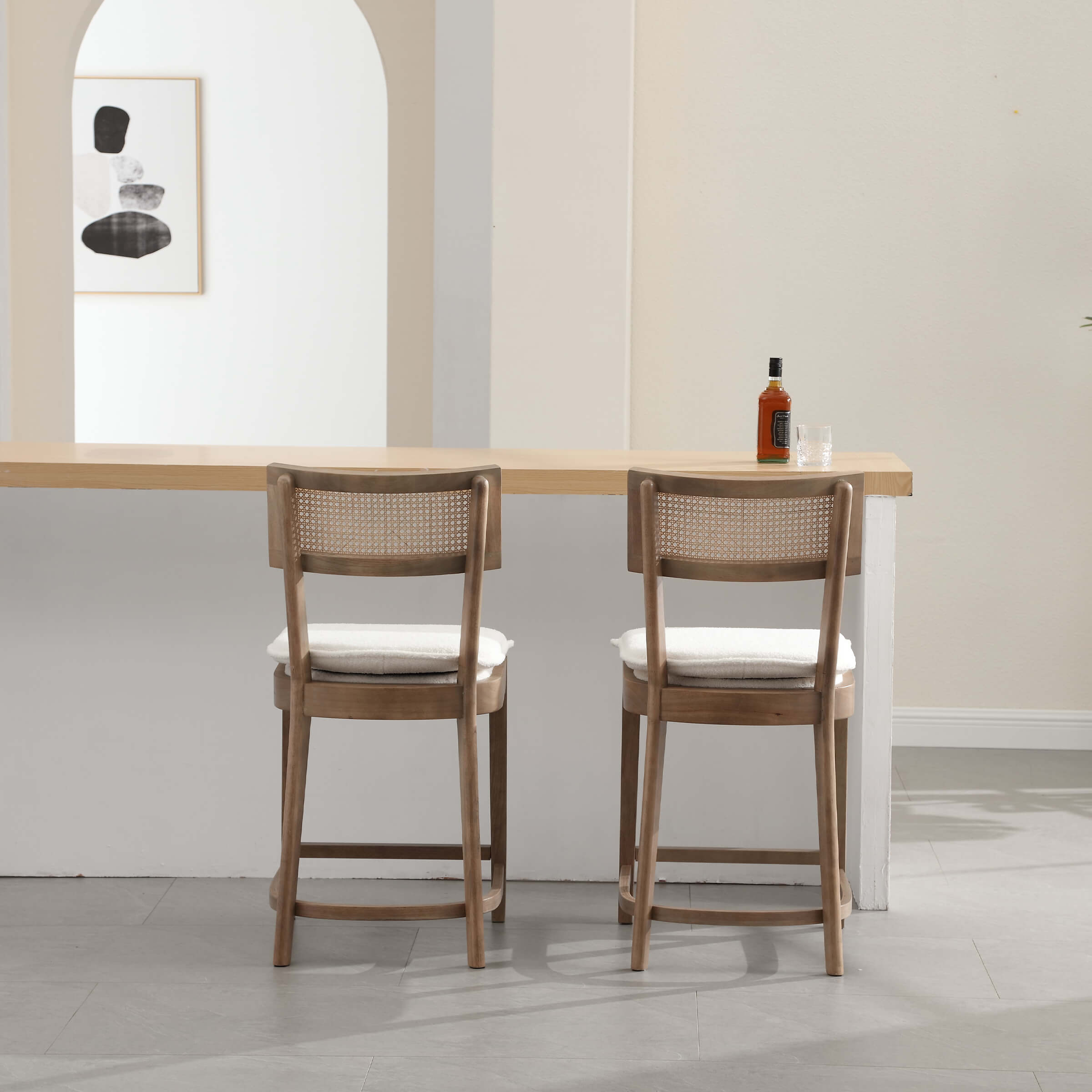 Two stools with white cushions at bar