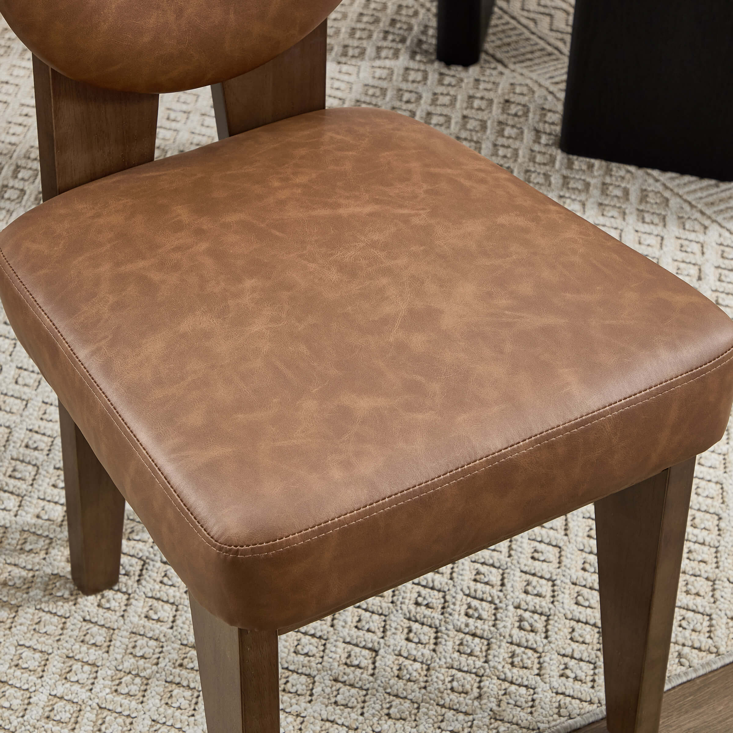 Brown leather chair seat close-up with stitching
