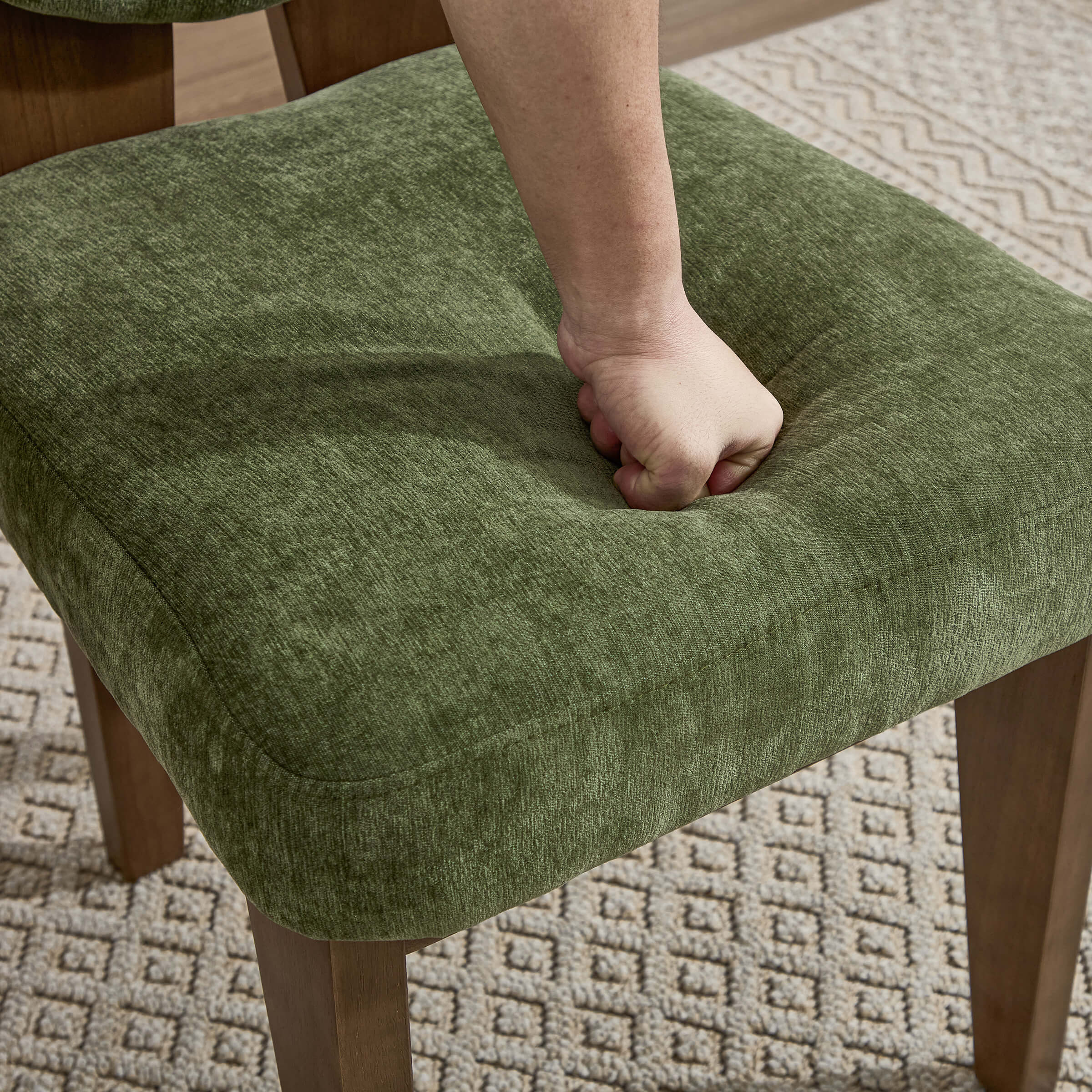 Close-up of green fabric seat and leg