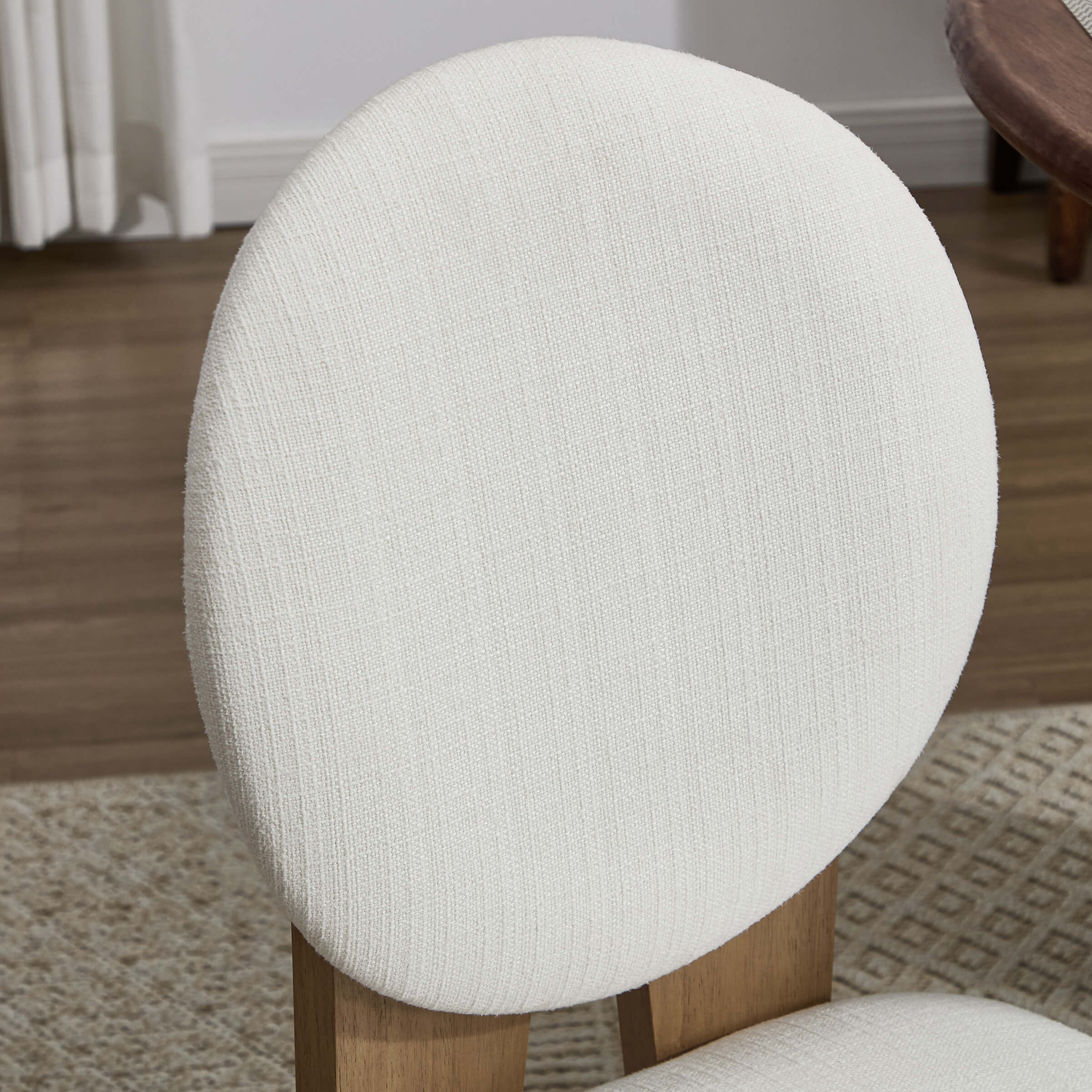 Close-up of cream rounded chair back and fabric texture