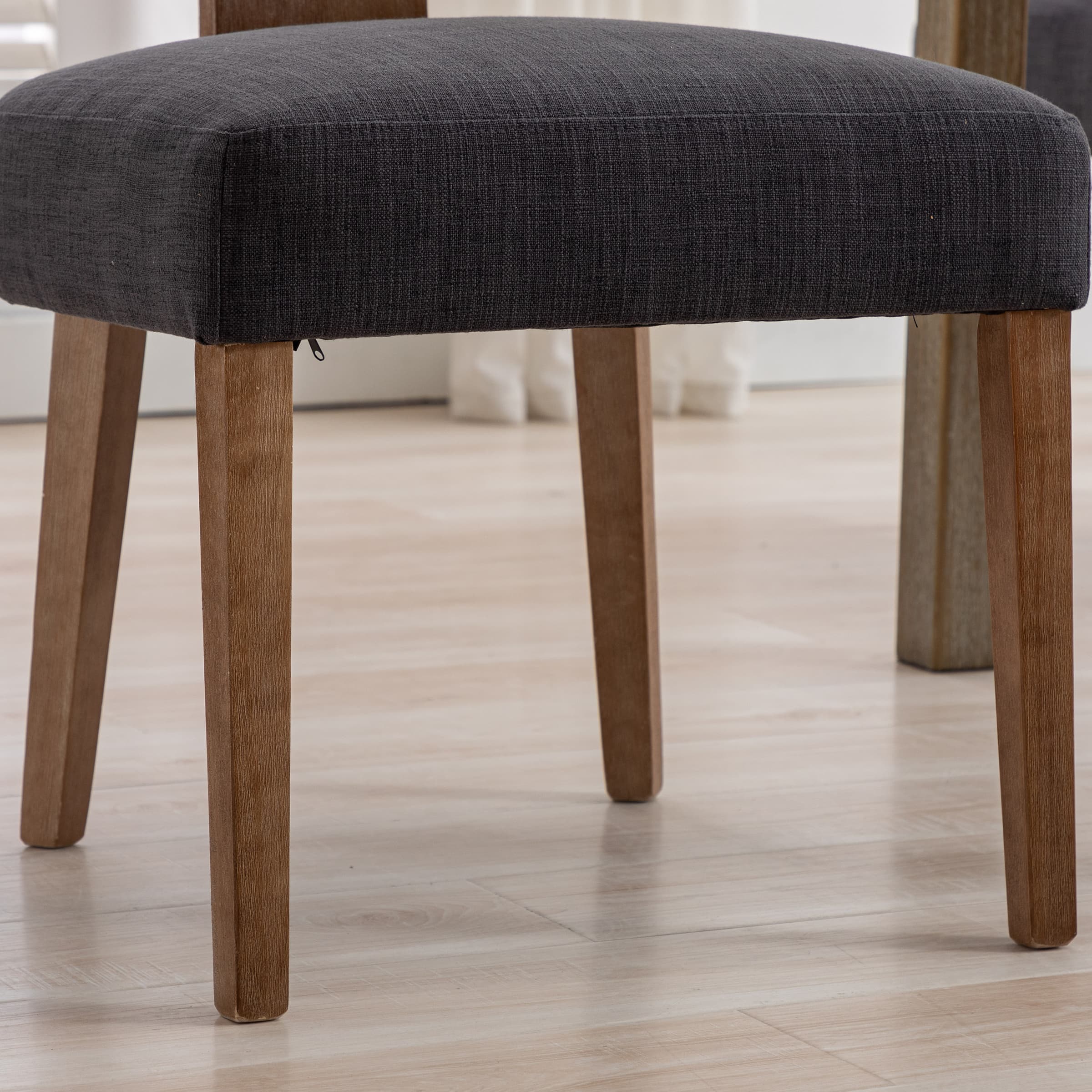 Section of chair showing leg and upholstery