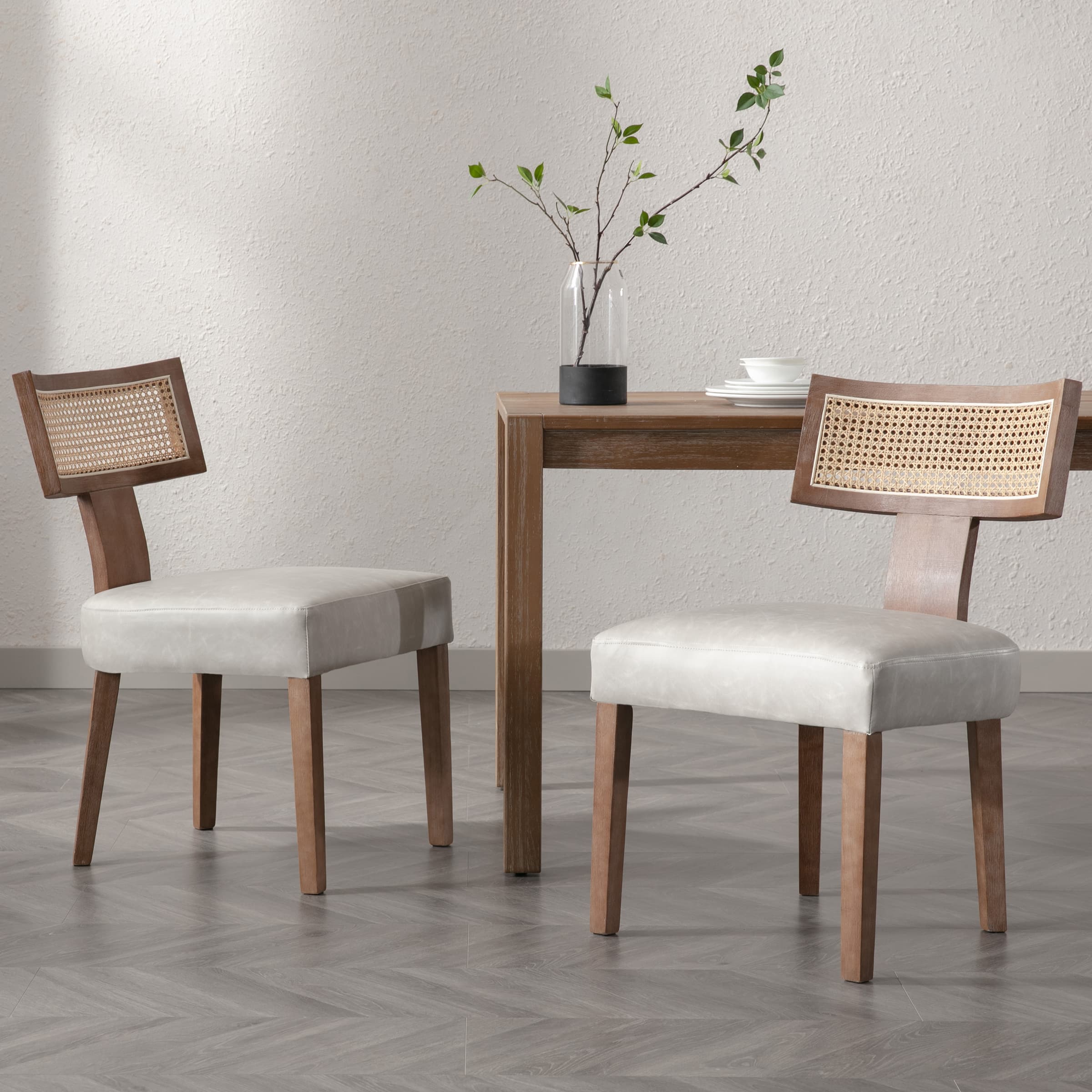 Chairs with cane back around table in white room