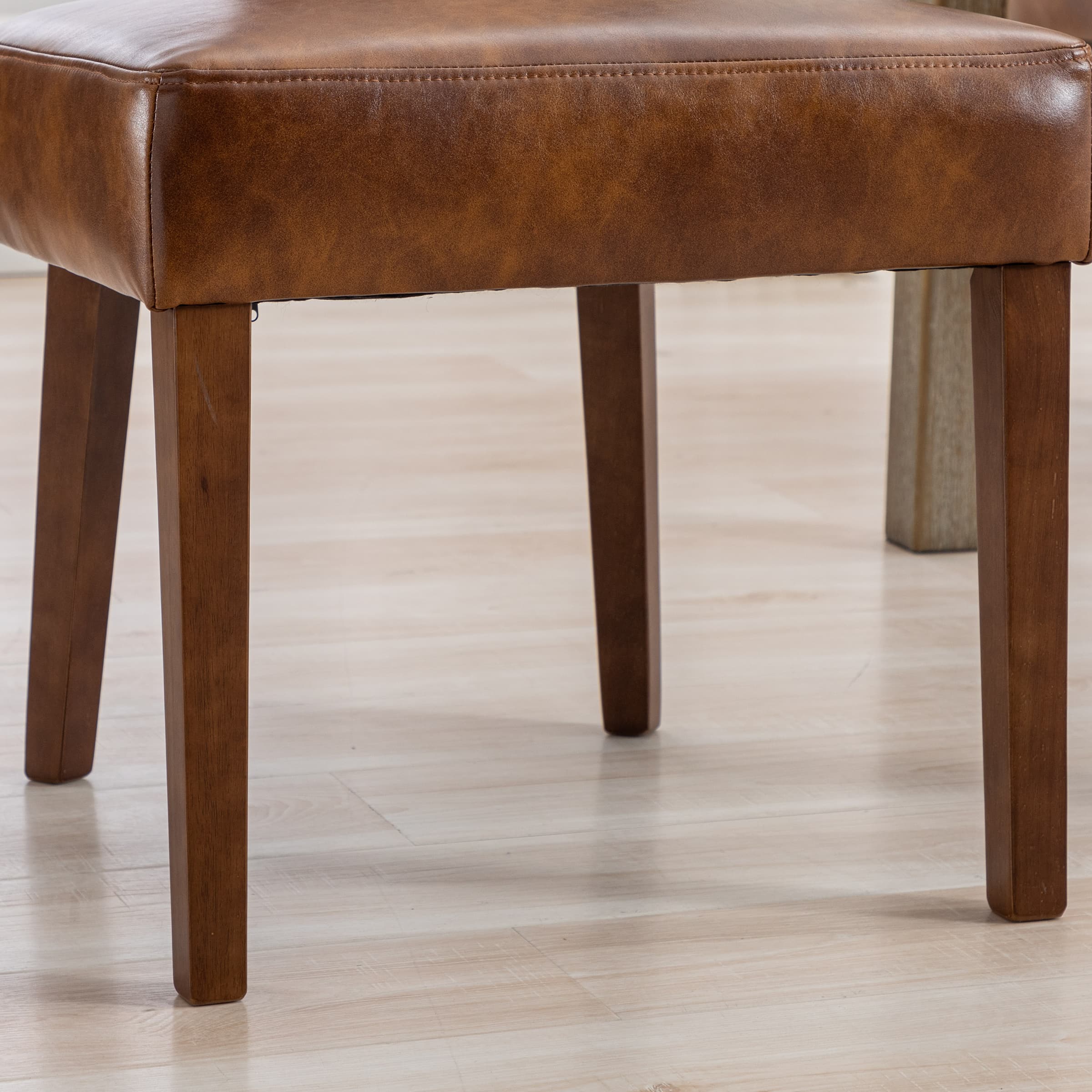 Two chairs around table with leather seats