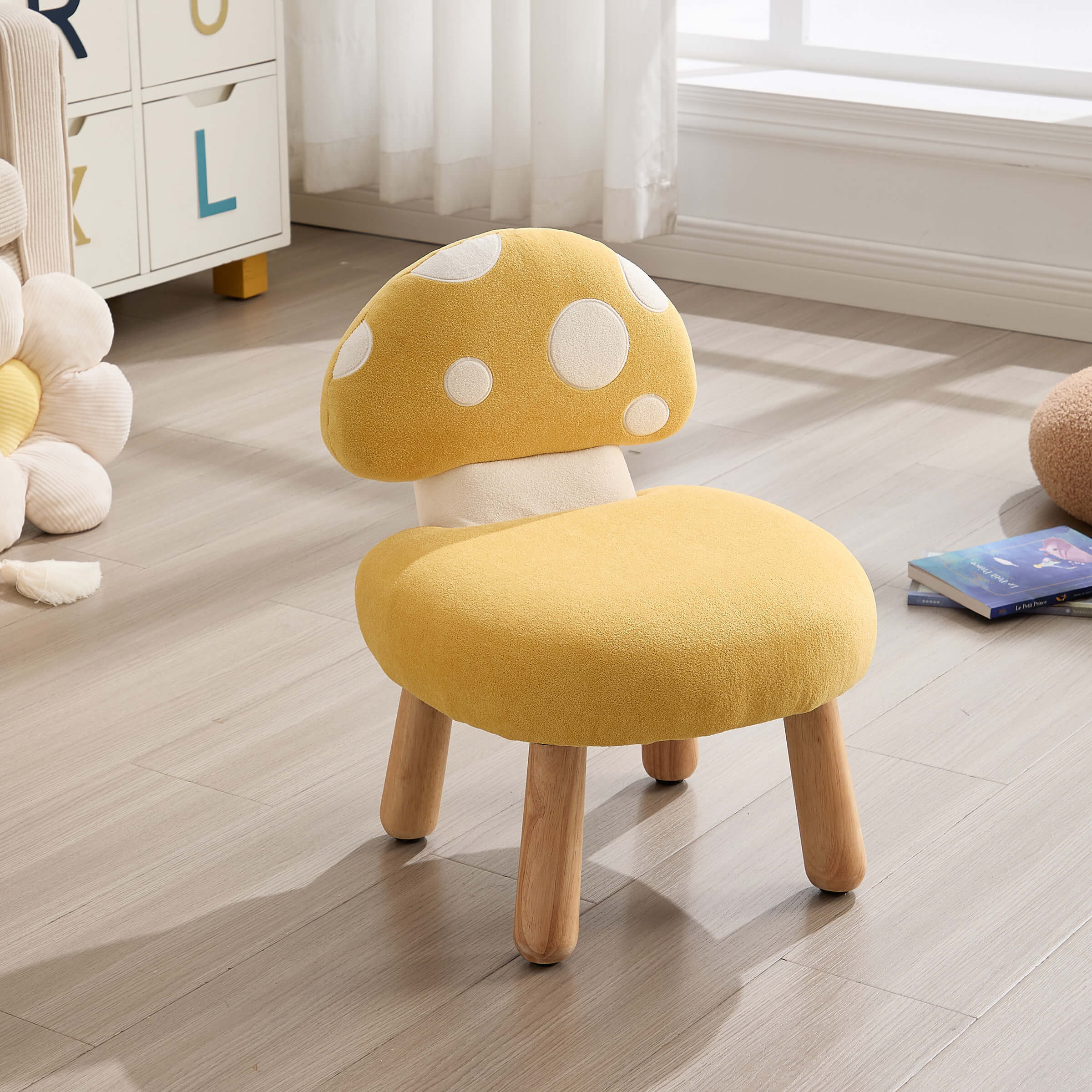 Yellow mushroom-shaped stool in a room with light wood flooring and a cabinet.
