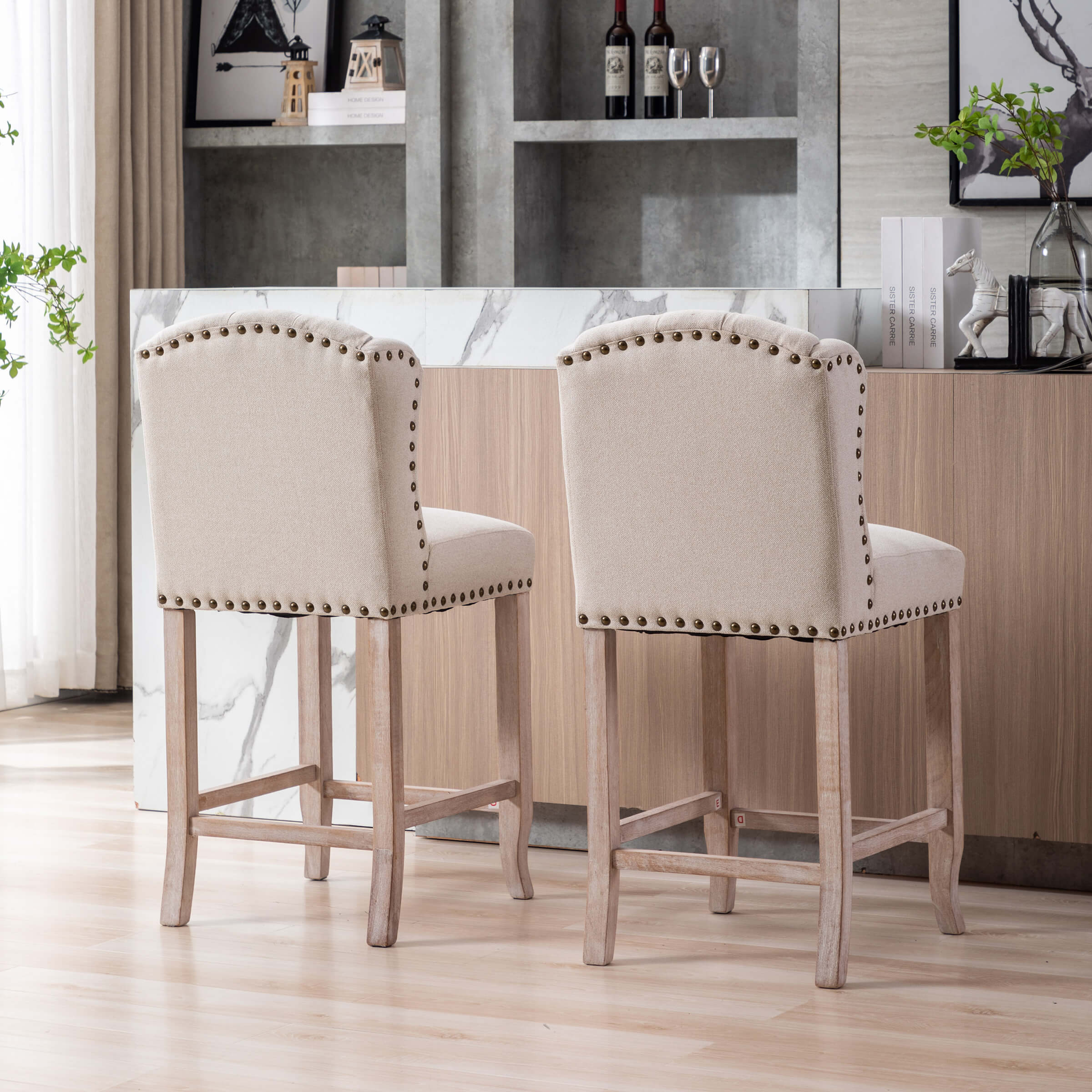 Two beige upholstered bar stools with tufted backs at a dining counter