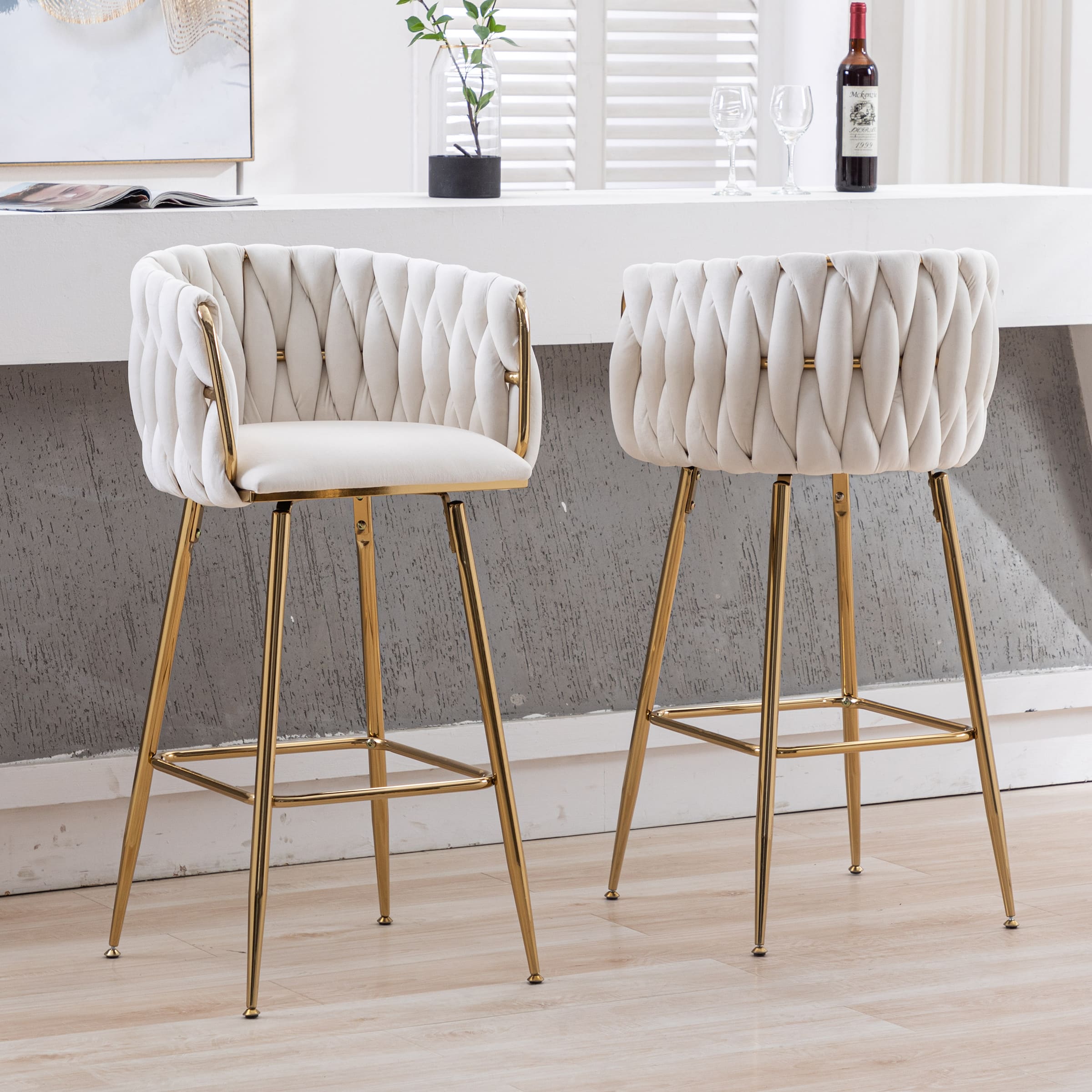 Two white tufted bar stools shown from a different angle