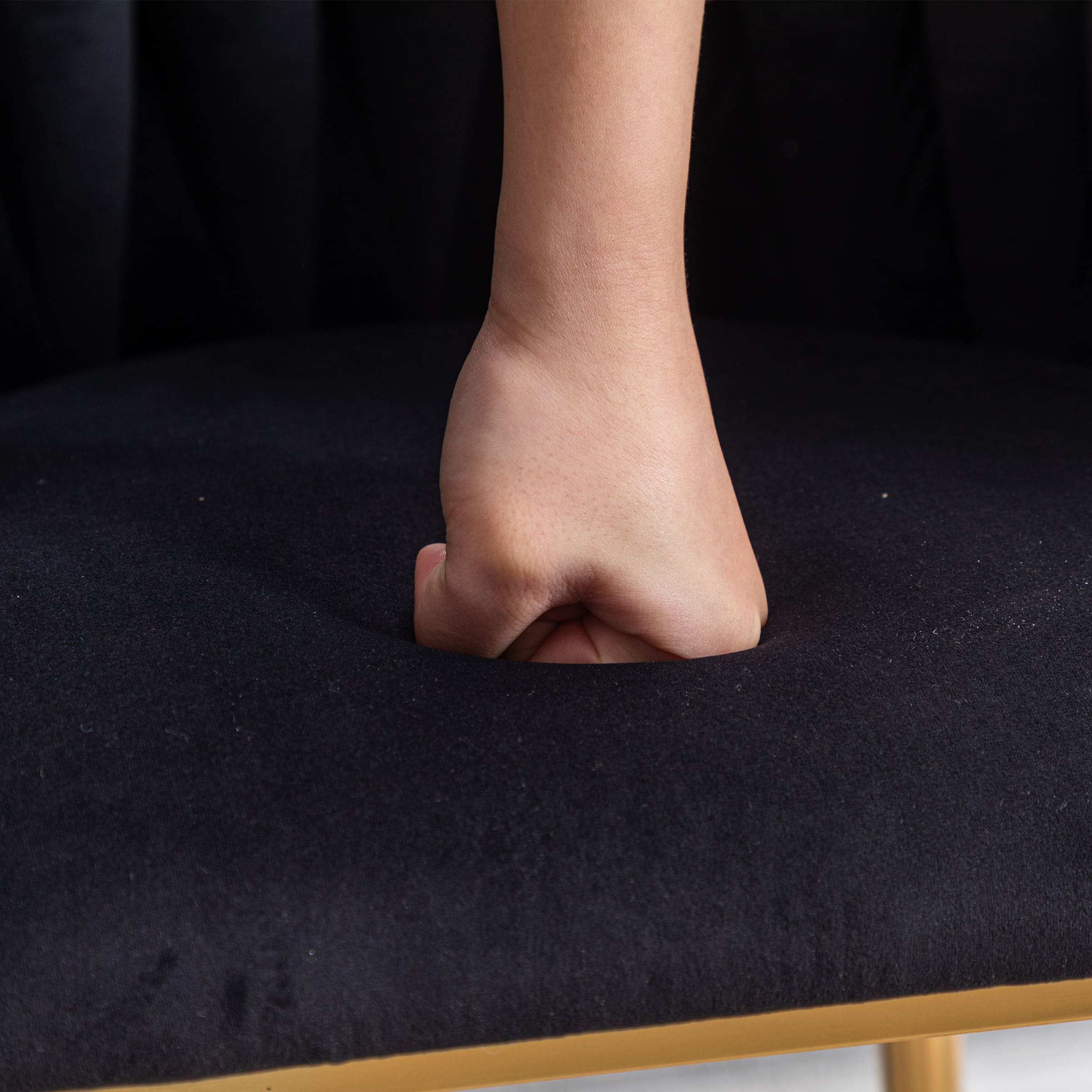 Foot pressing into navy upholstery