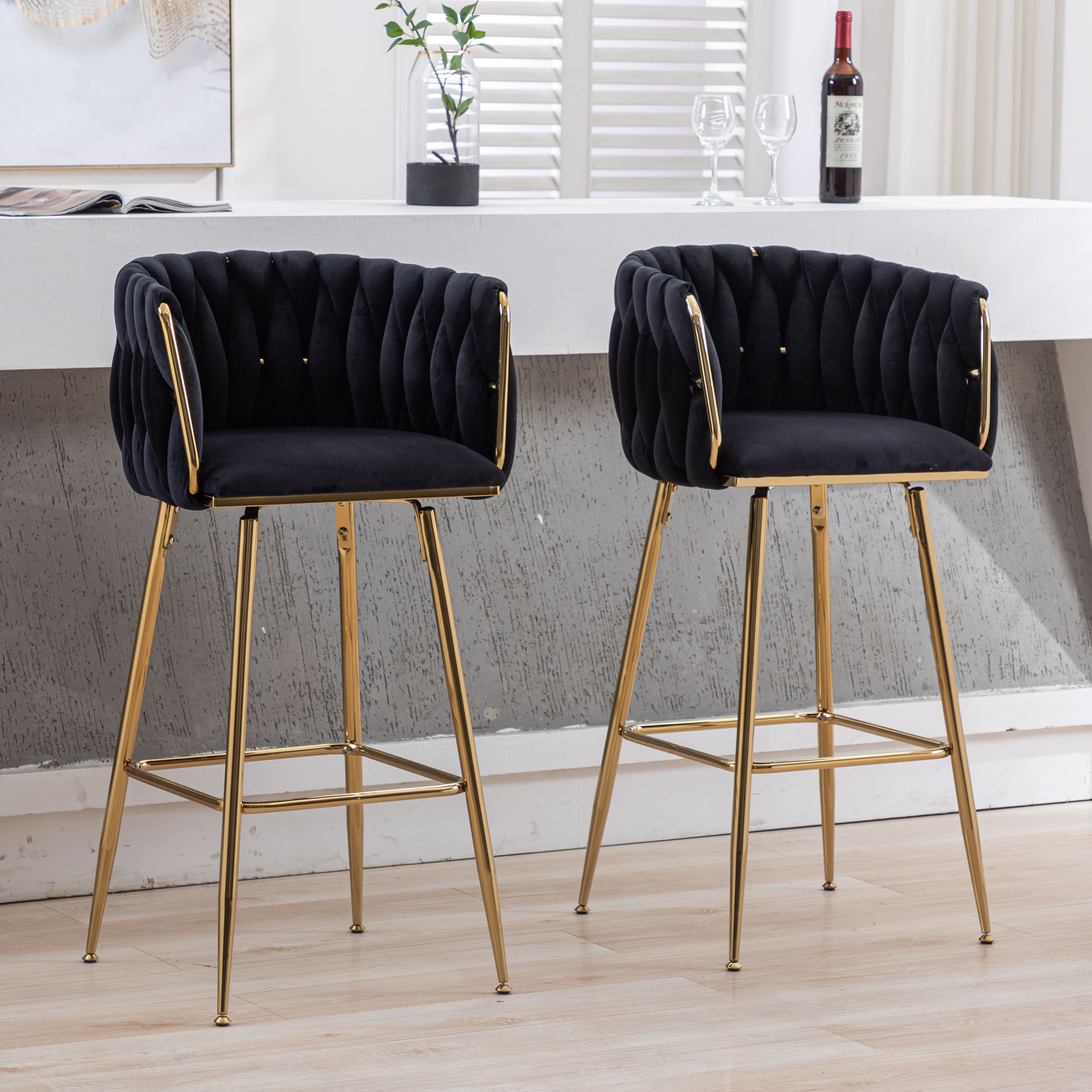 Two similar stools in dark upholstery