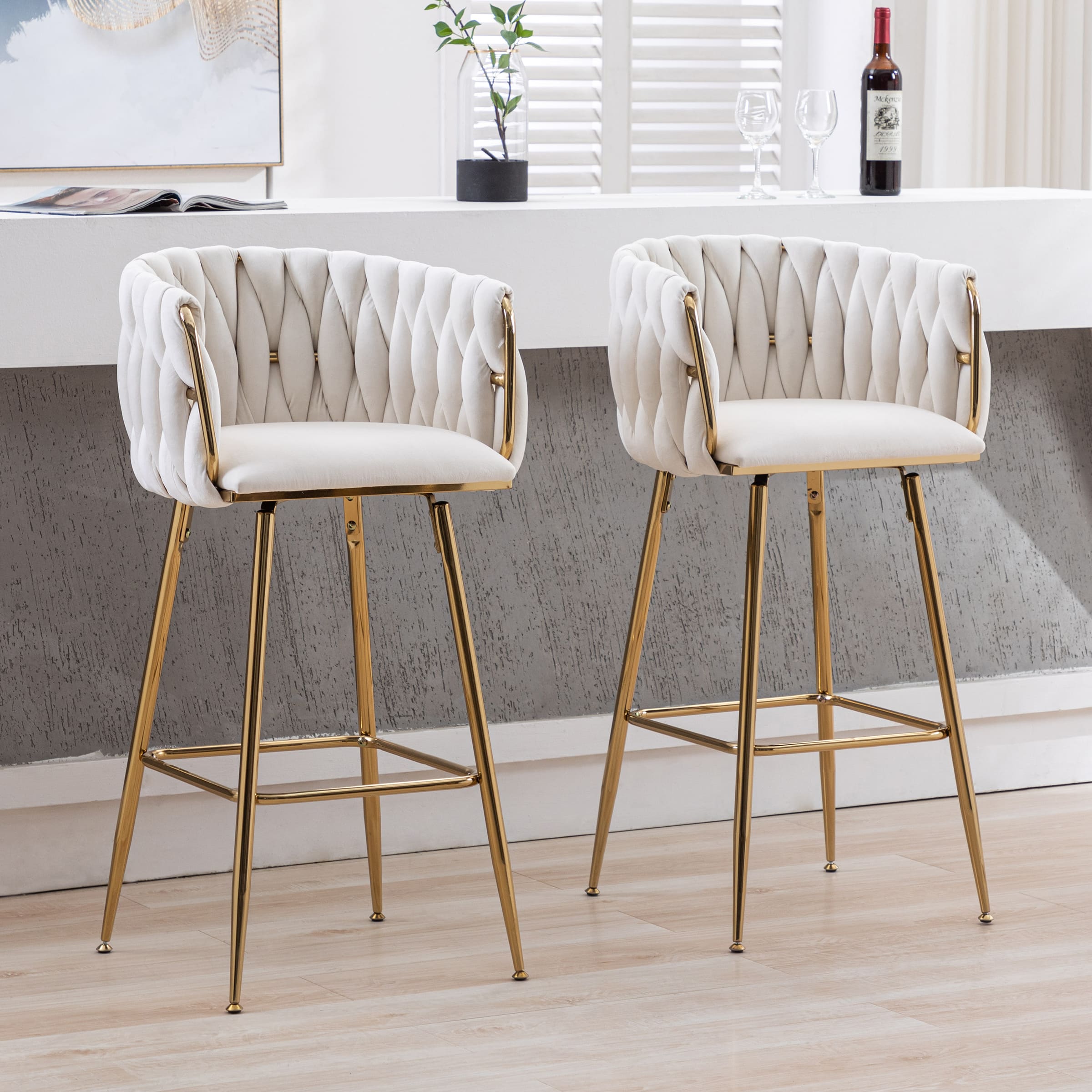 Two identical white tufted bar stools seen from a side angle