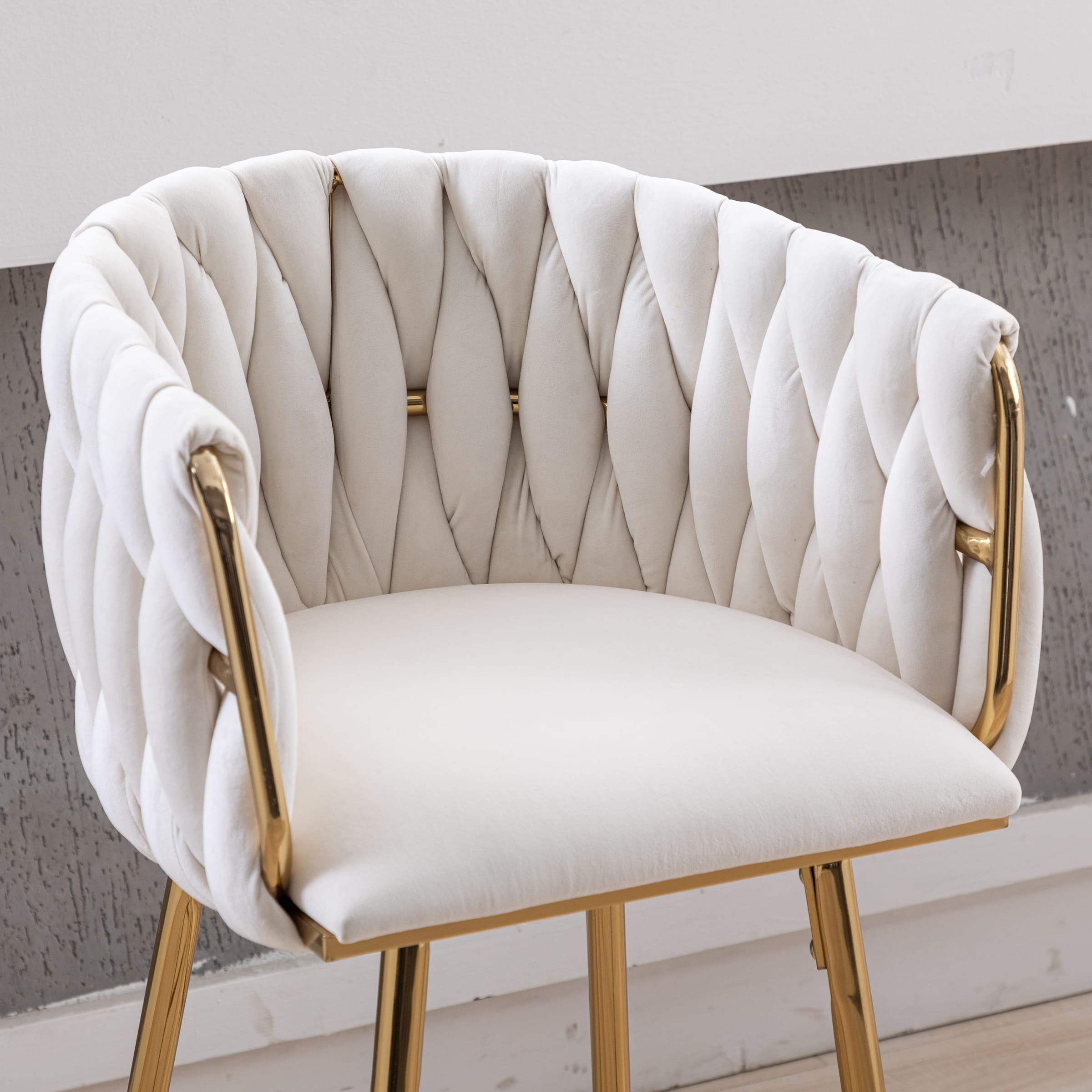 Close-up of white cushioned seat and gold frame