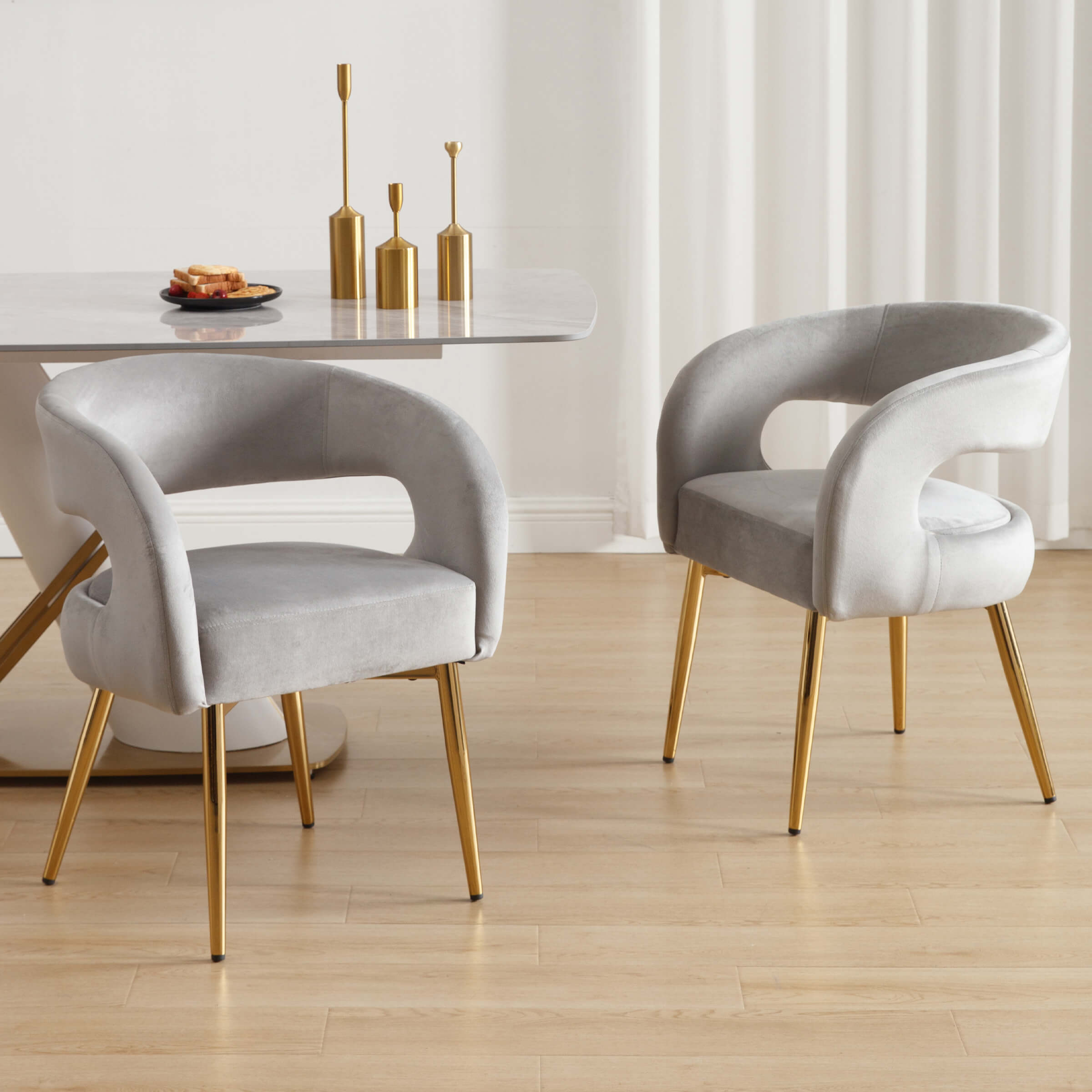 Grey velvet chairs around a table