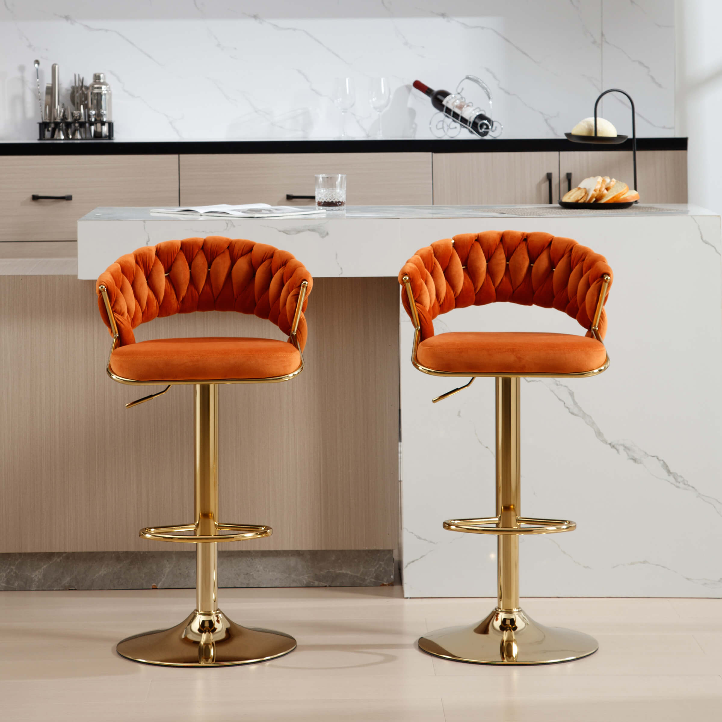 Two orange velvet woven swivel bar stools at a kitchen island