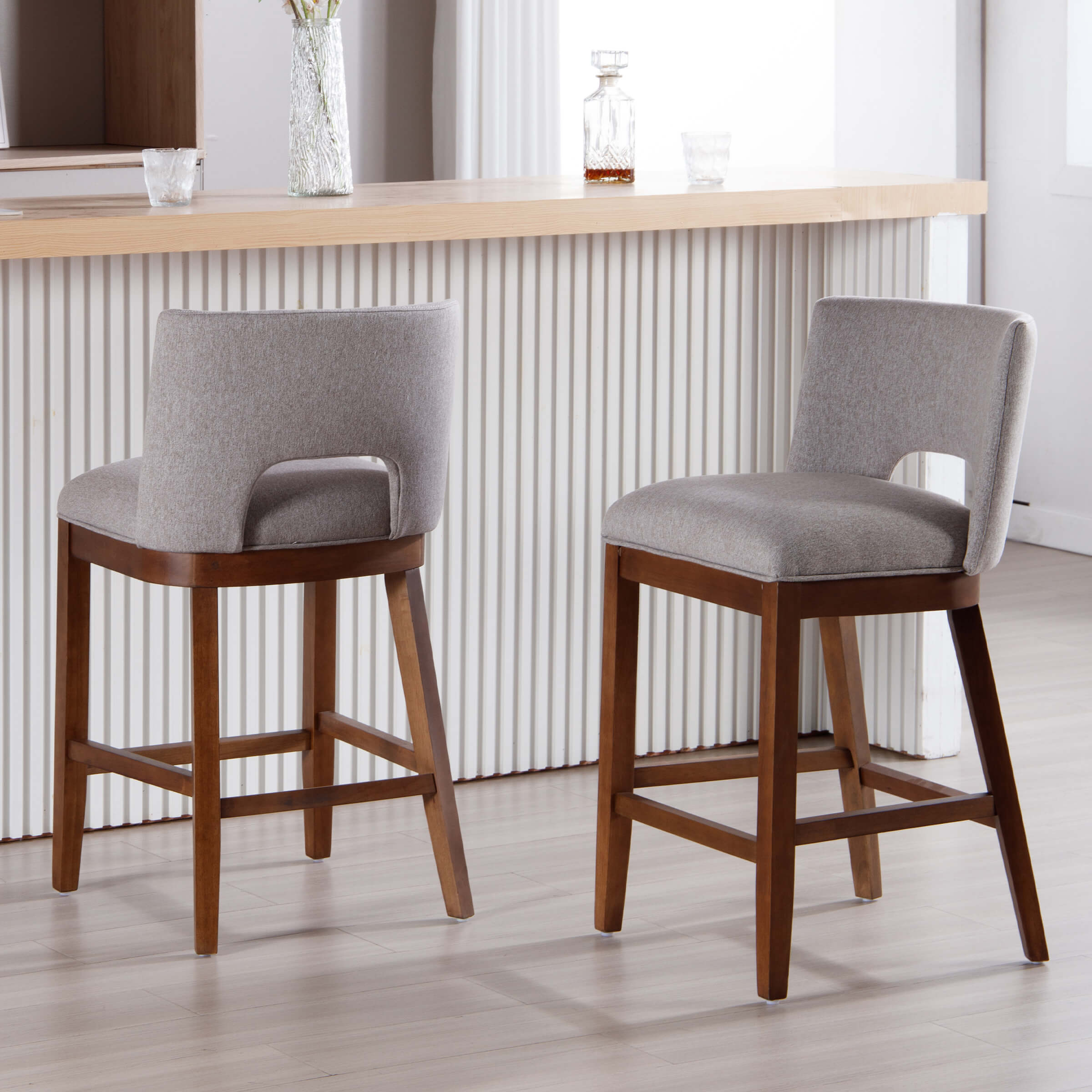 Two beige stools by bar
