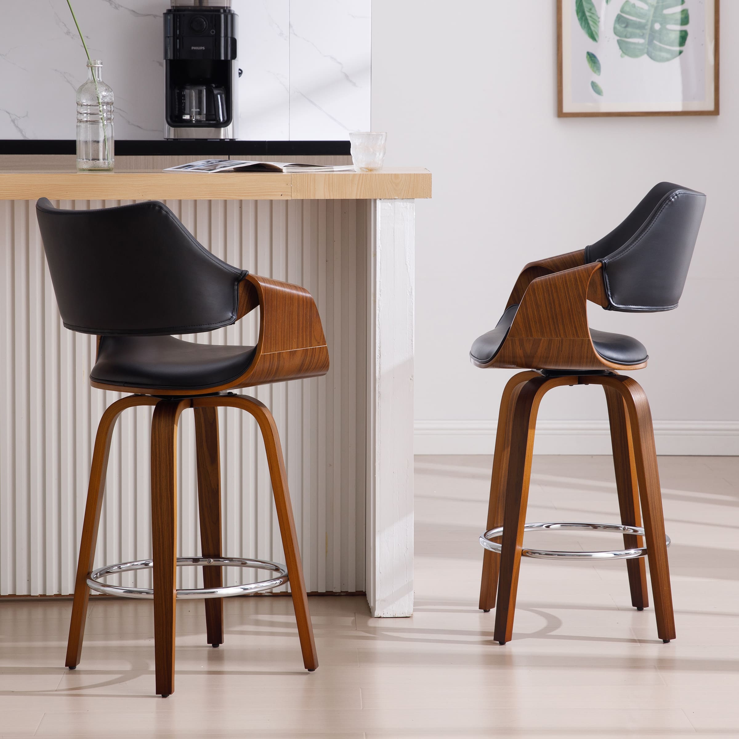Two chairs with black seats and wooden frames
