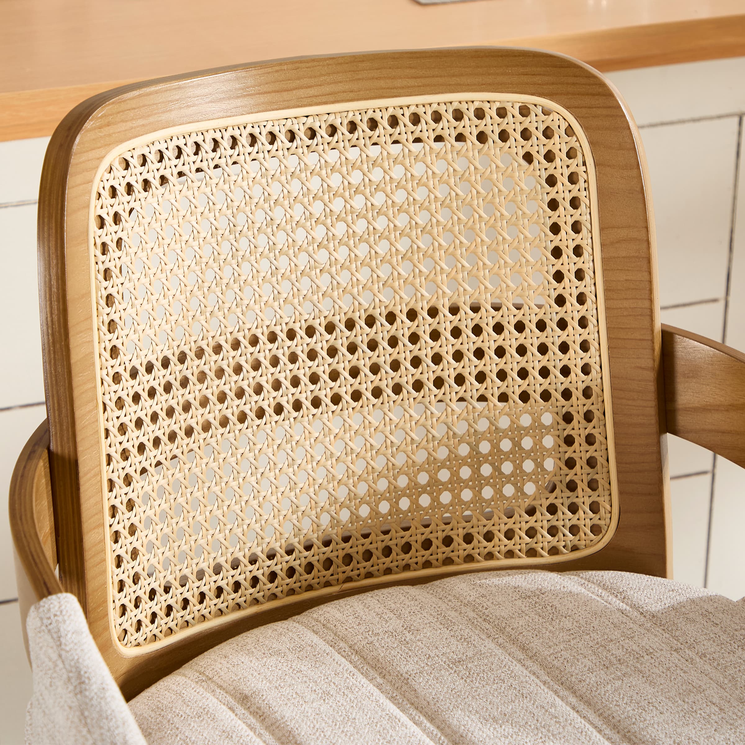Close-up of woven cane back panel in wooden frame