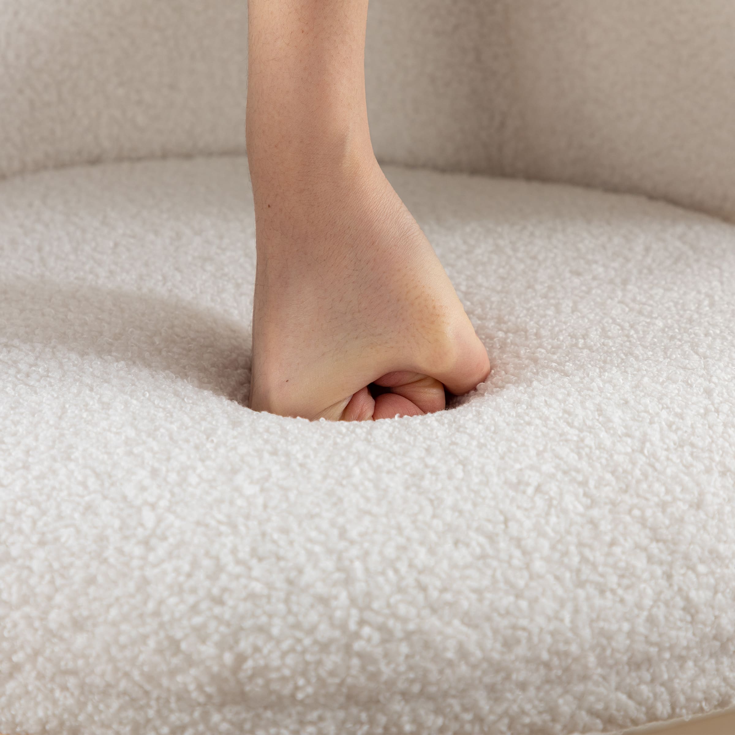 Hands pressing fabric of seat upholstery