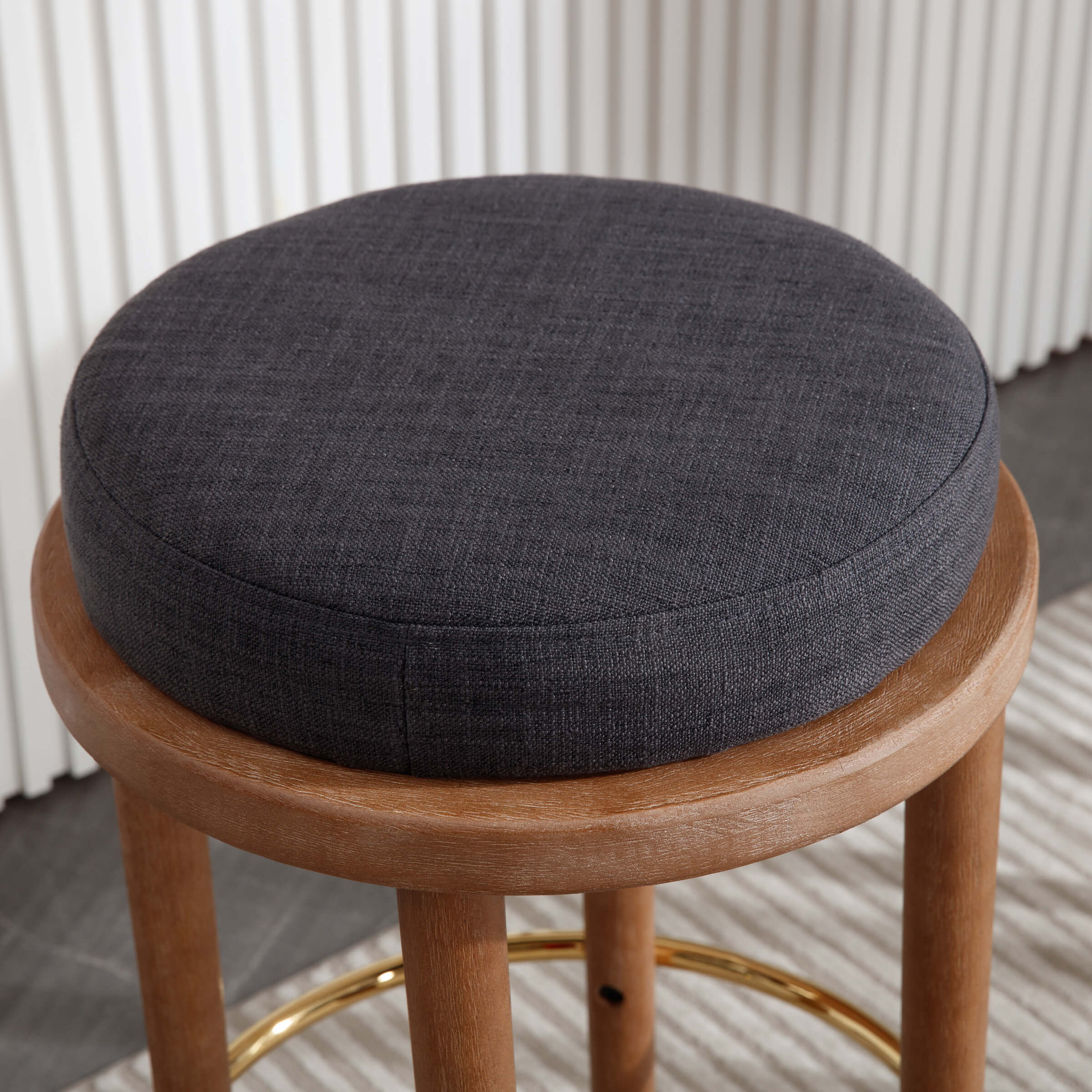Stool with dark cushion in a modern interior
