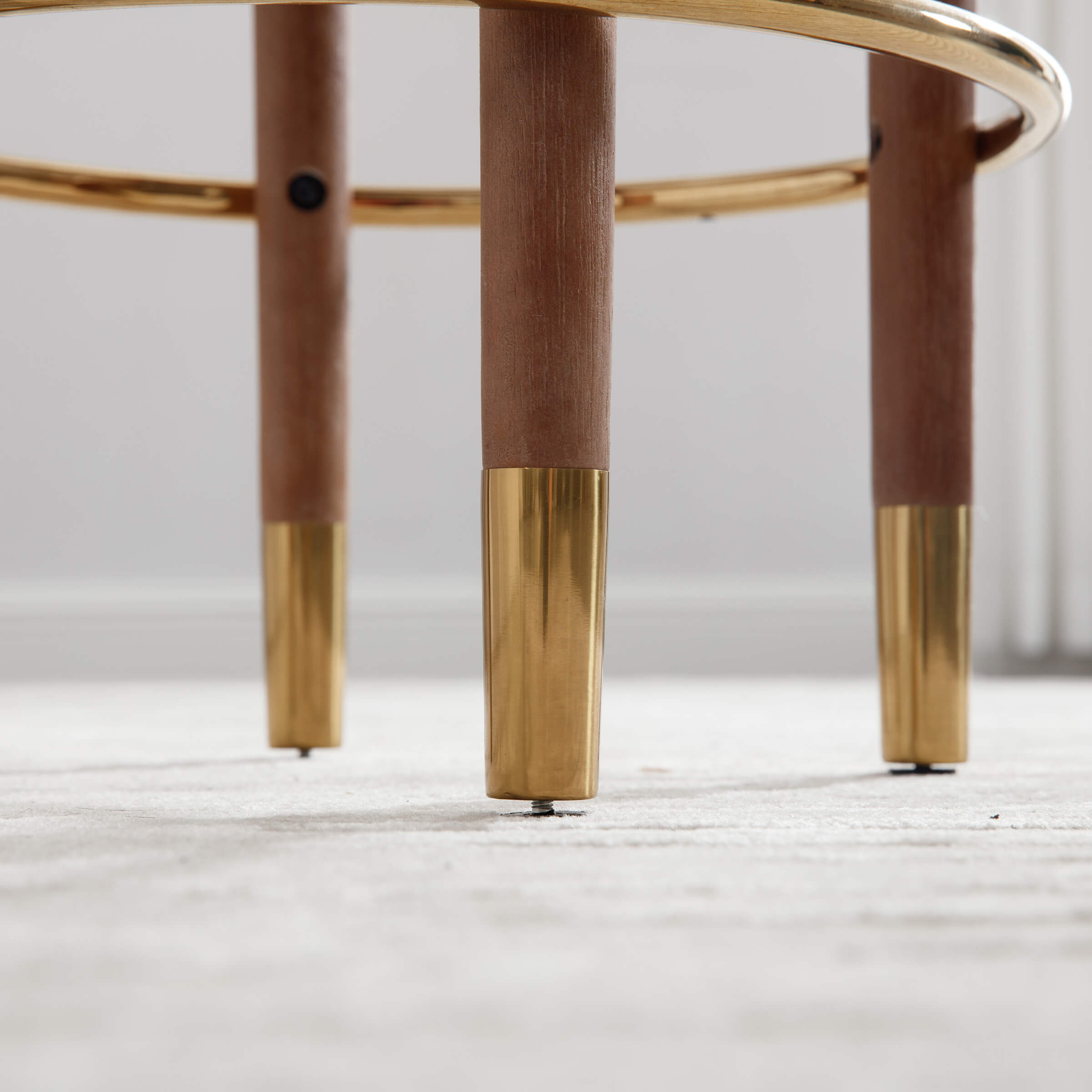 Bottom of stool legs with gold-finished foot caps