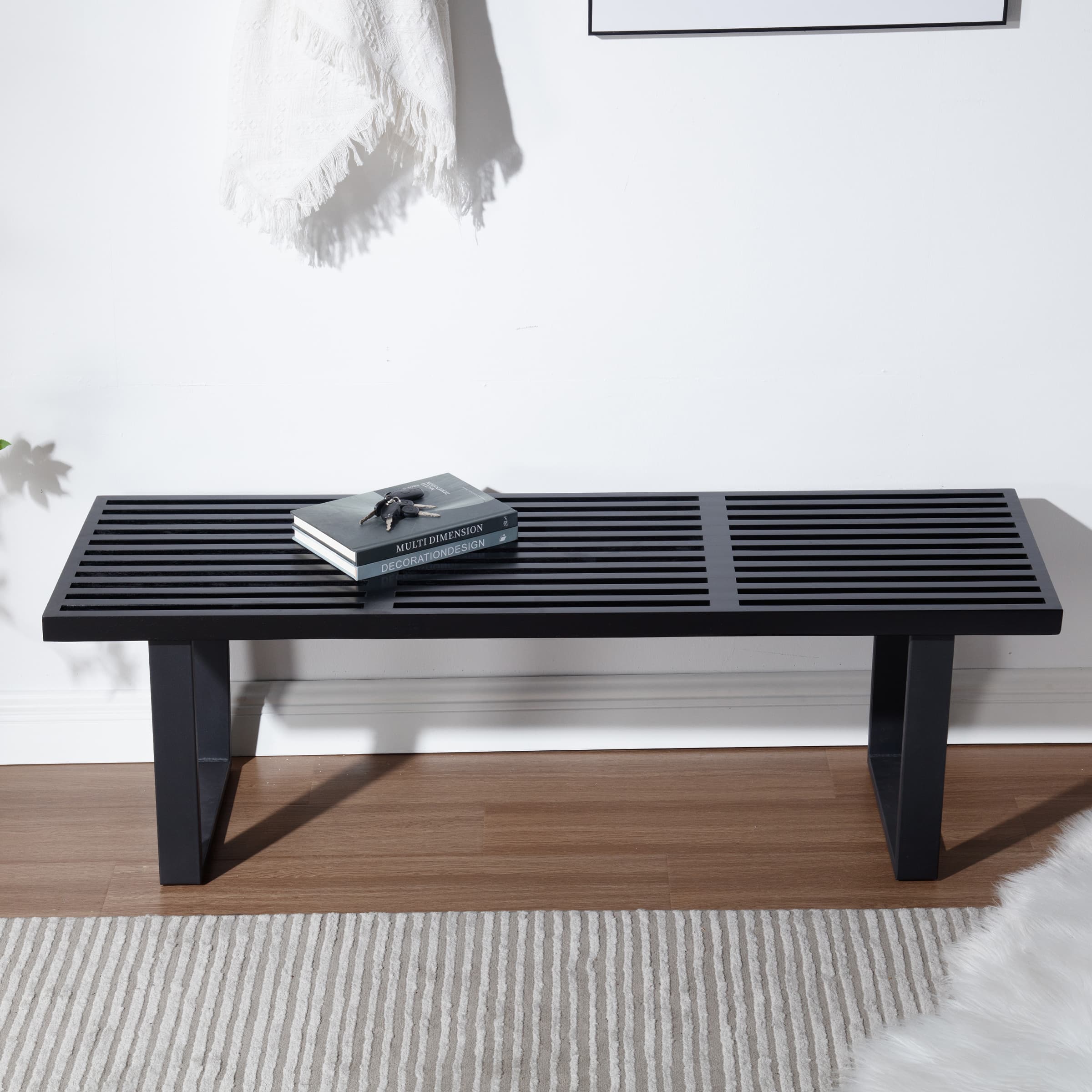 Side angle view of black slatted bench