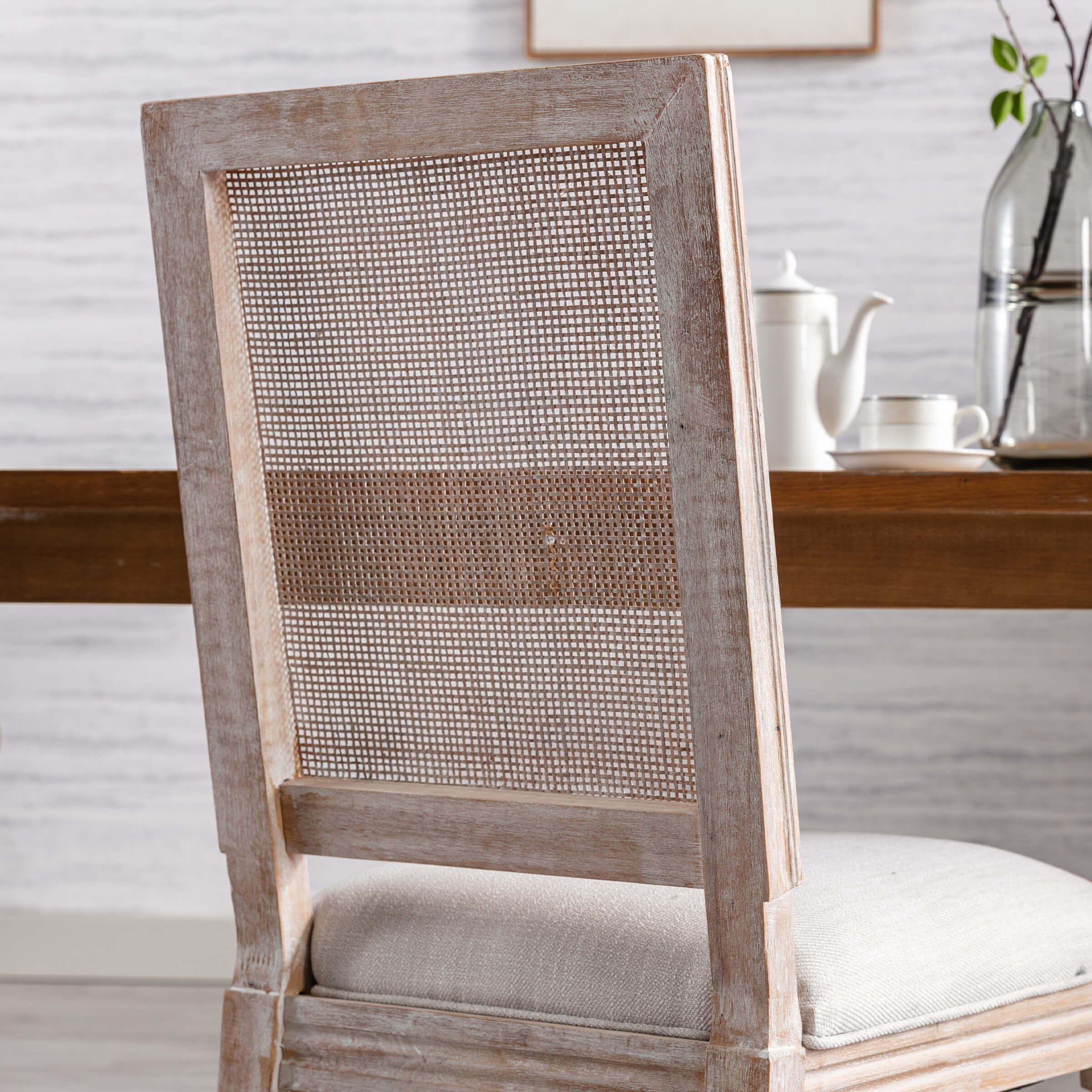 Front corner of chair showing caning and cushion