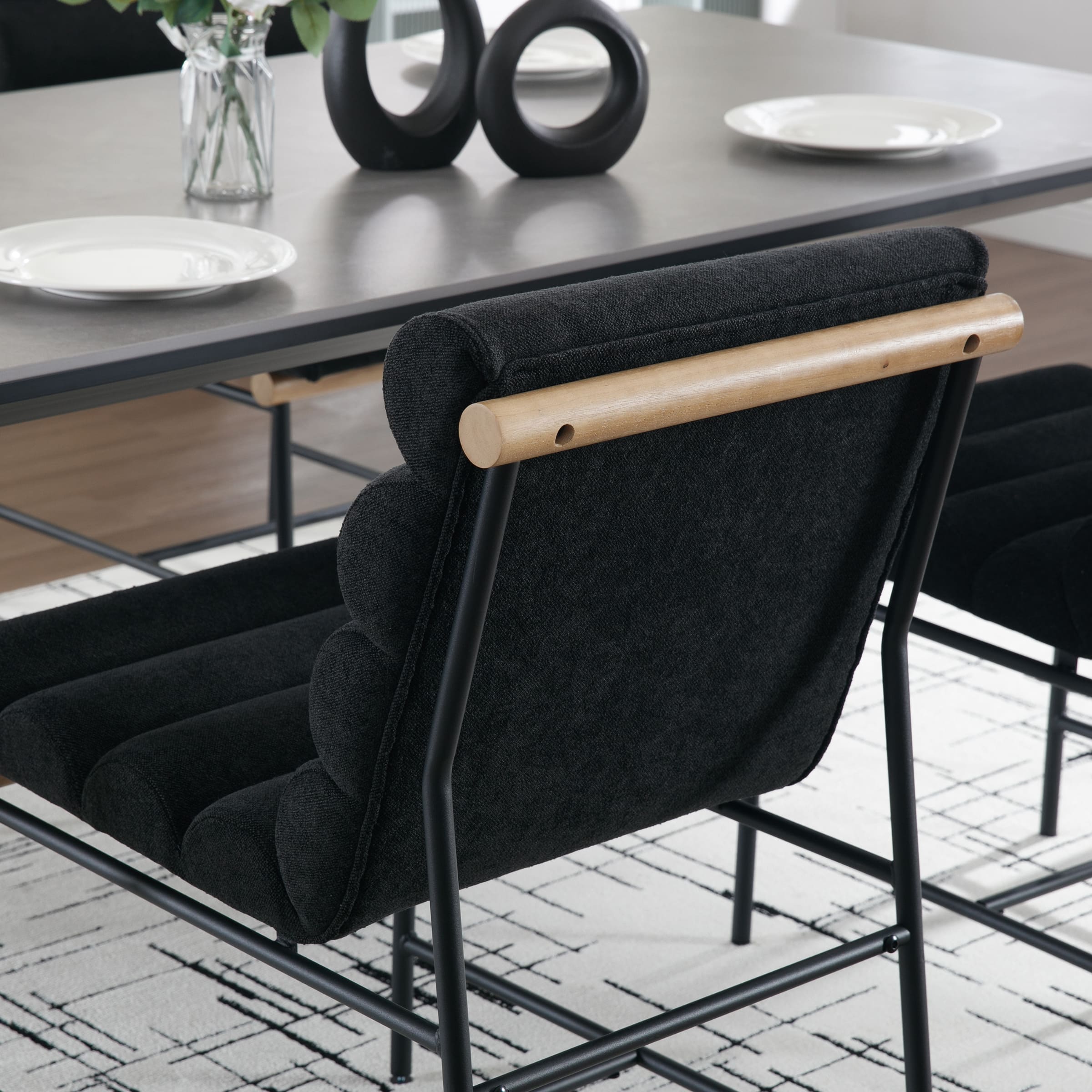 Back of dining chair with wooden armrest and black metal frame