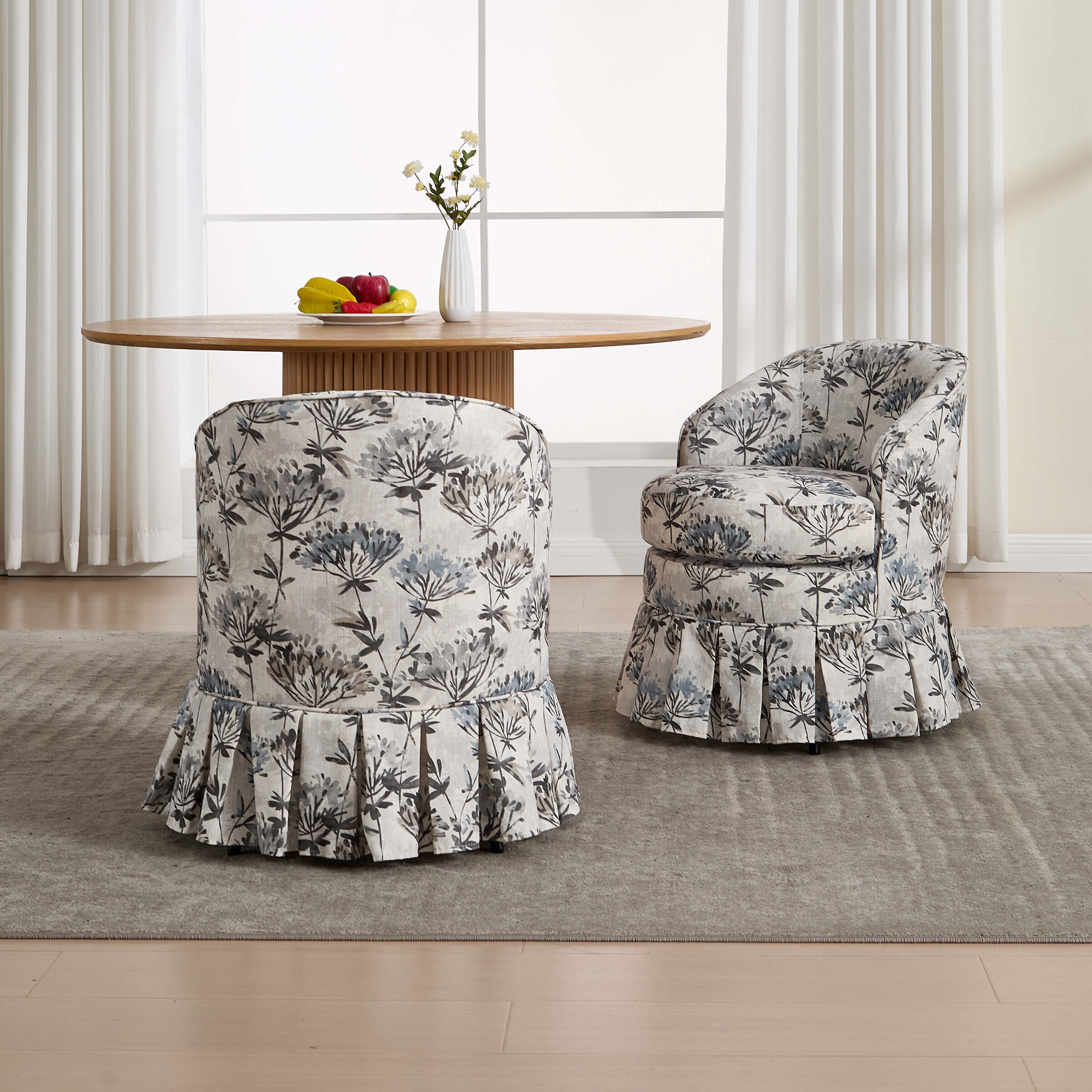 Set of four upholstered dining chairs with pleated skirts around round table