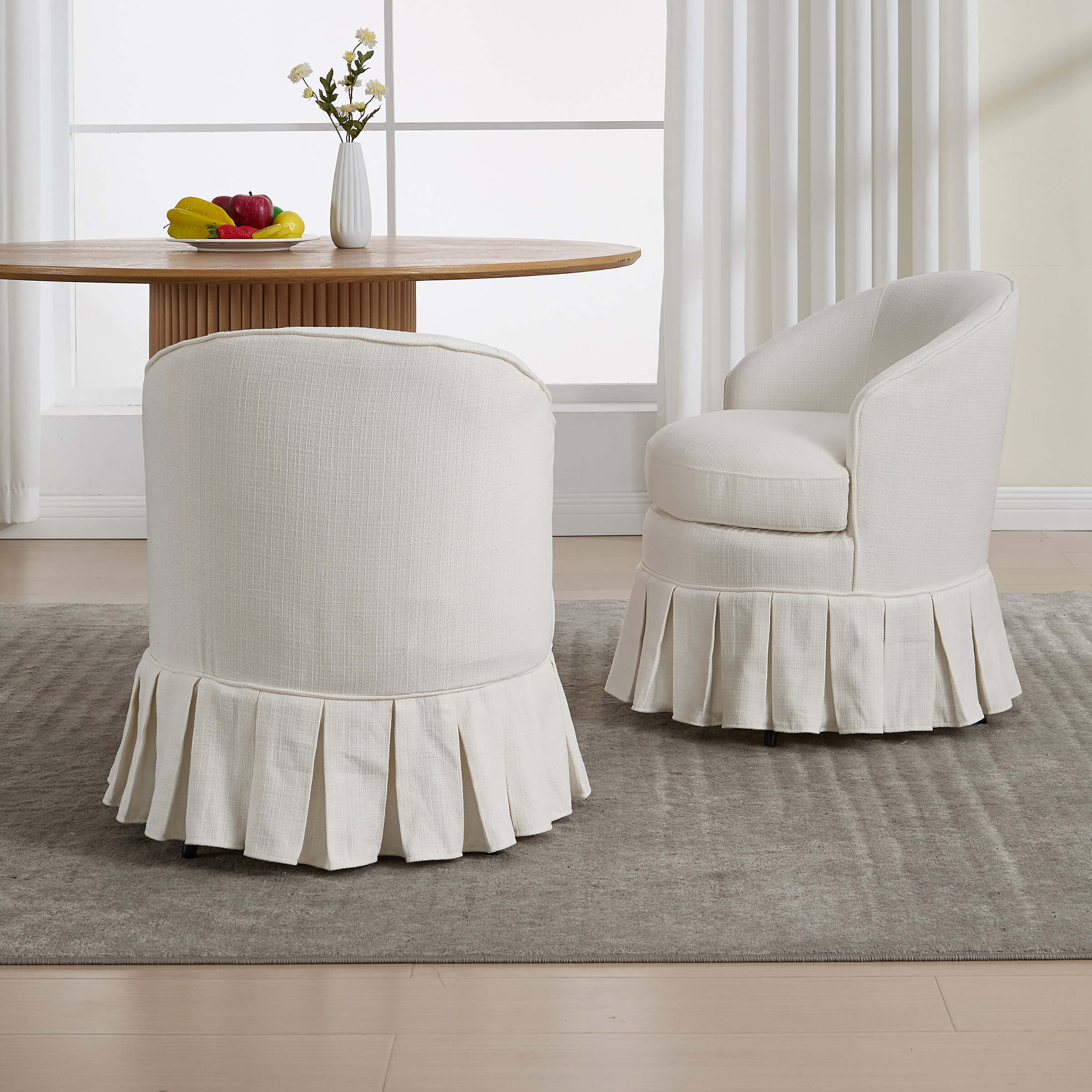 White seating with pleated skirts and table