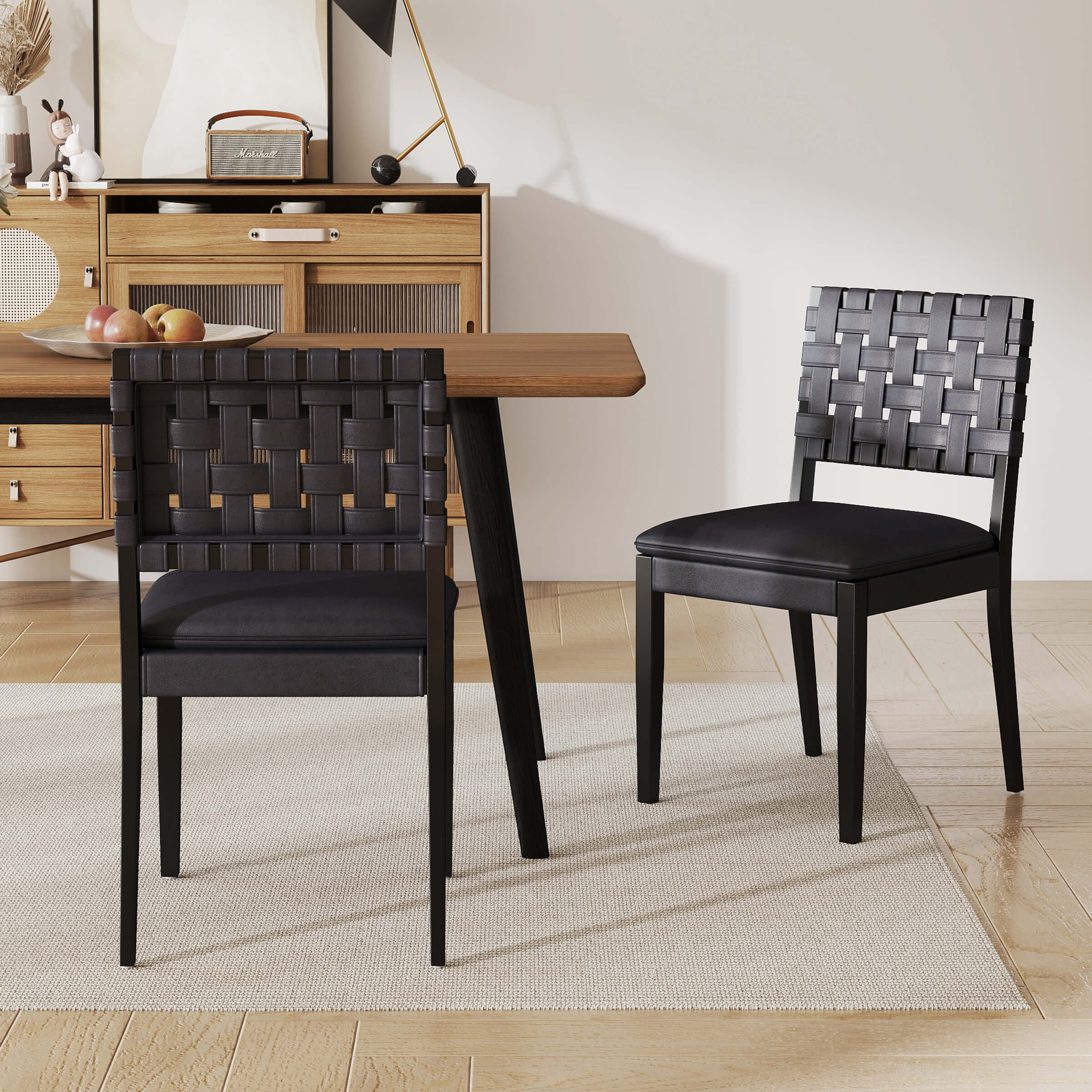 Two woven rattan dining chairs at a dining table from side angle