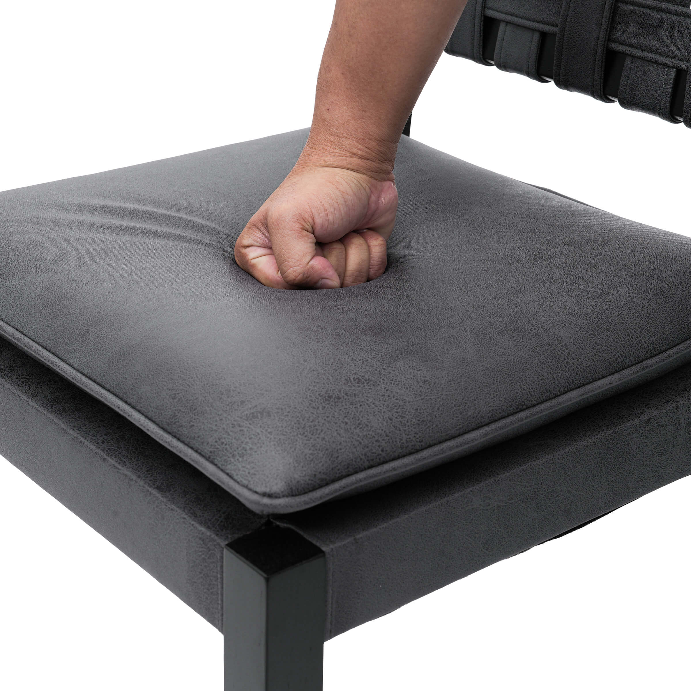 Close-up of chair cushion being pressed