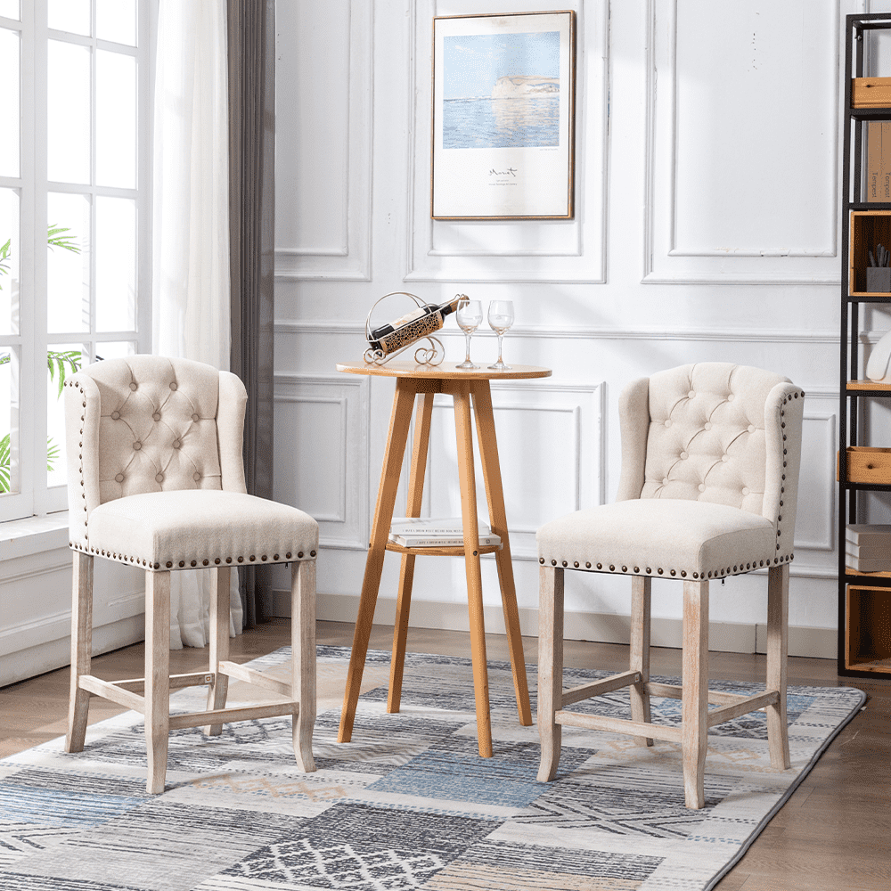 Two beige tufted stools with table in a bright modern room